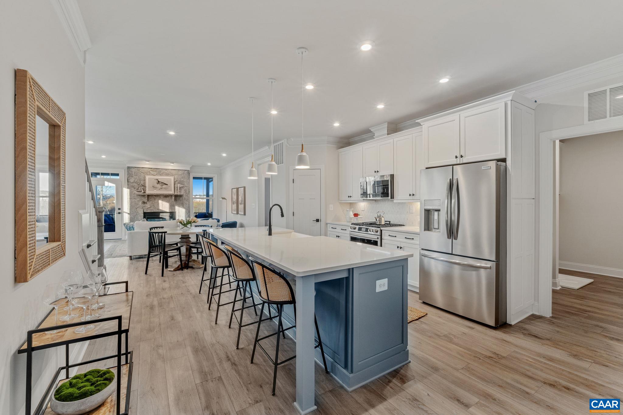 This move-in ready, new construction end-unit Bayberry villa in The Grove at Brookhill offers low-maintenance living in a peaceful wooded setting just off Route 29 North. Inside, you'll find a main-level primary suite with a private bath and walk-in closet, plus an open kitchen with quartz counters, soft-close cabinets, and a walk-in pantry. The main level also includes a mudroom with laundry and a cozy indoor-outdoor stone fireplace that connects to a screened porch. Upstairs are two additional bedrooms, a full bath, a loft, a pocket office, and extra storage. The home sits on a walkout basement foundation and includes a 2-car garage. Quality finishes and practical design round out this easy-living home. Actual photos!