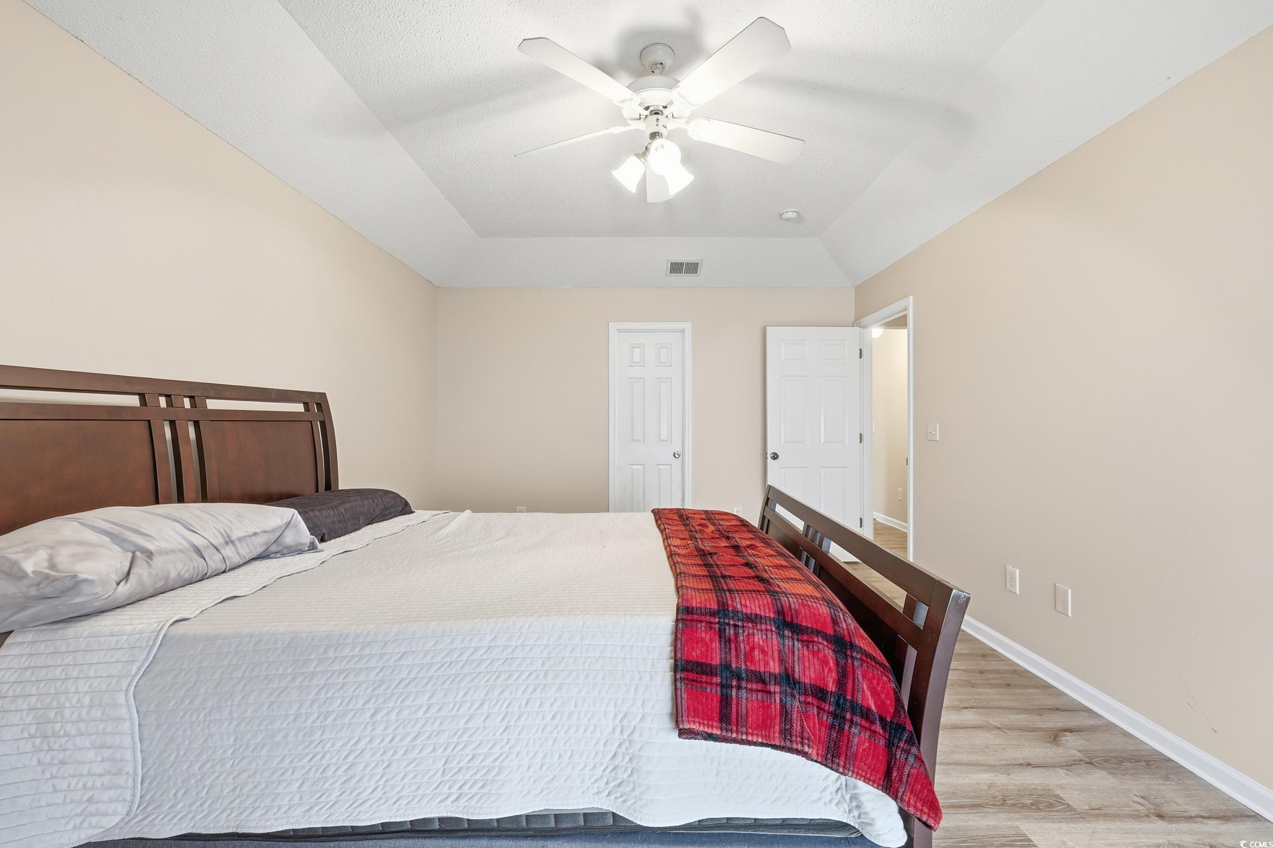 Bedroom with wood finished floors and a ceiling fan