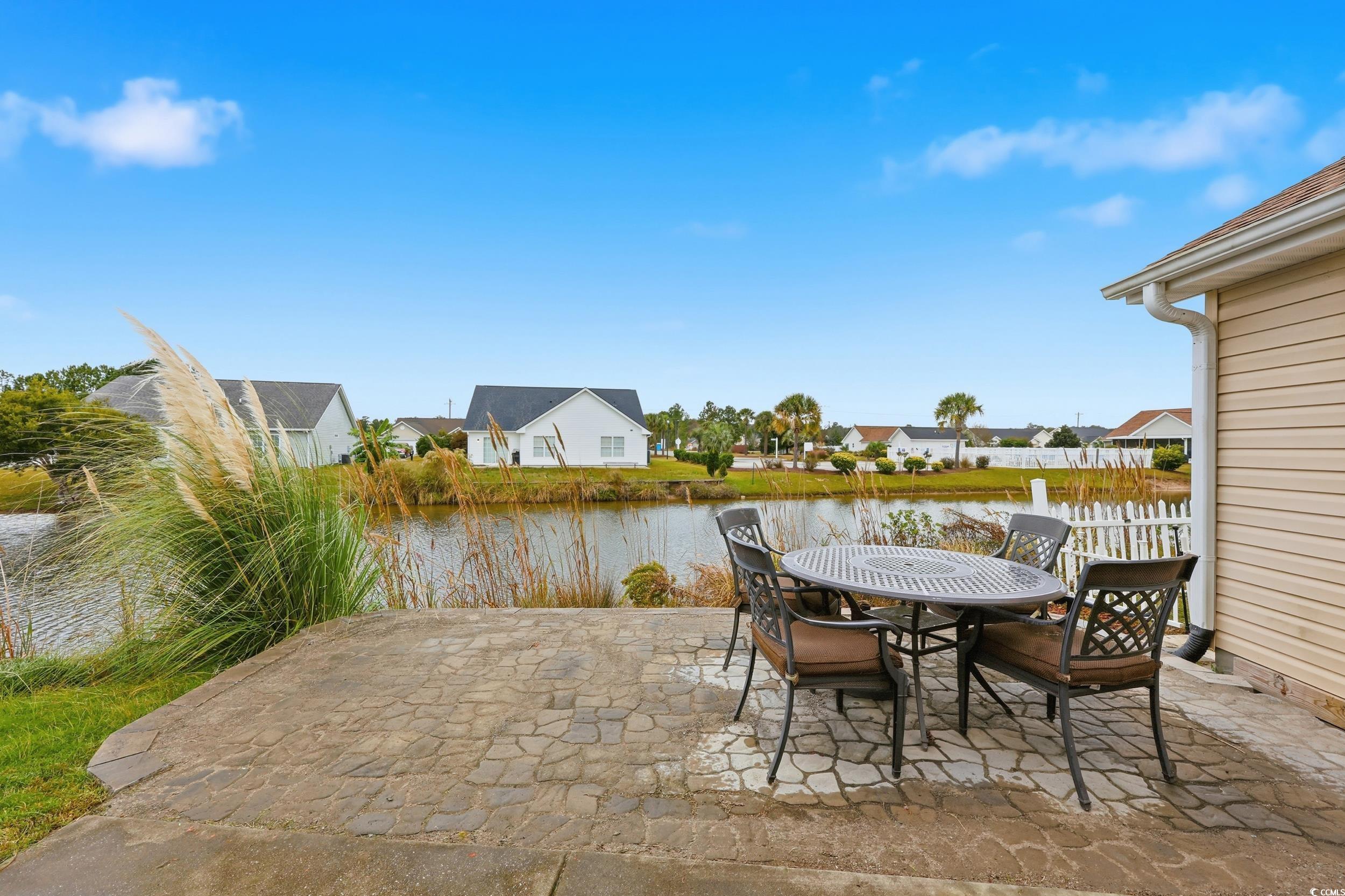 View of patio / terrace featuring a residential view, a water view, and outdoor dining area