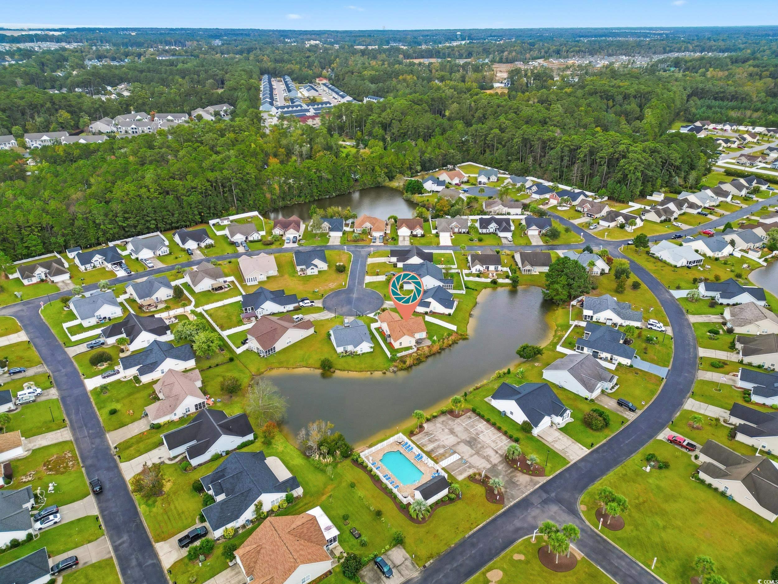 Aerial view of property's location featuring nearby suburban area and a nearby body of water