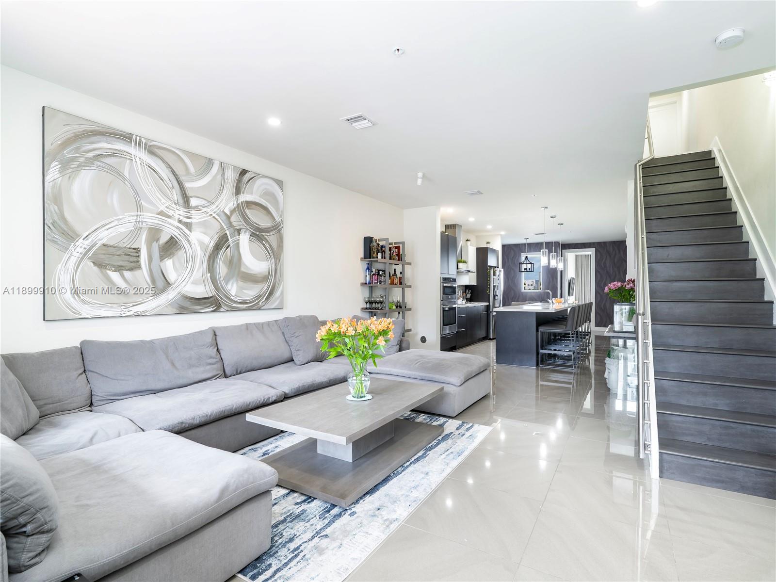 Exceptional opportunity to own in Landmark, one of Doral’s most sought-after communities. This modern three-story condo offers 1,923 Sq.Ft. of stylish living with 3 bedrooms, 2.5 baths, and a private one-car garage. Enjoy open, light-filled interiors, elegant porcelain flooring, and a chef’s kitchen with premium appliances, a large quartz island with seating for six, and a built-in wine cooler. The primary suite features a spacious walk-in closet and spa-style bath with dual floating vanities and a glass-enclosed shower. Residents have access to Landmark’s luxurious clubhouse with a resort-style pool, fitness center, and social areas designed for modern living.