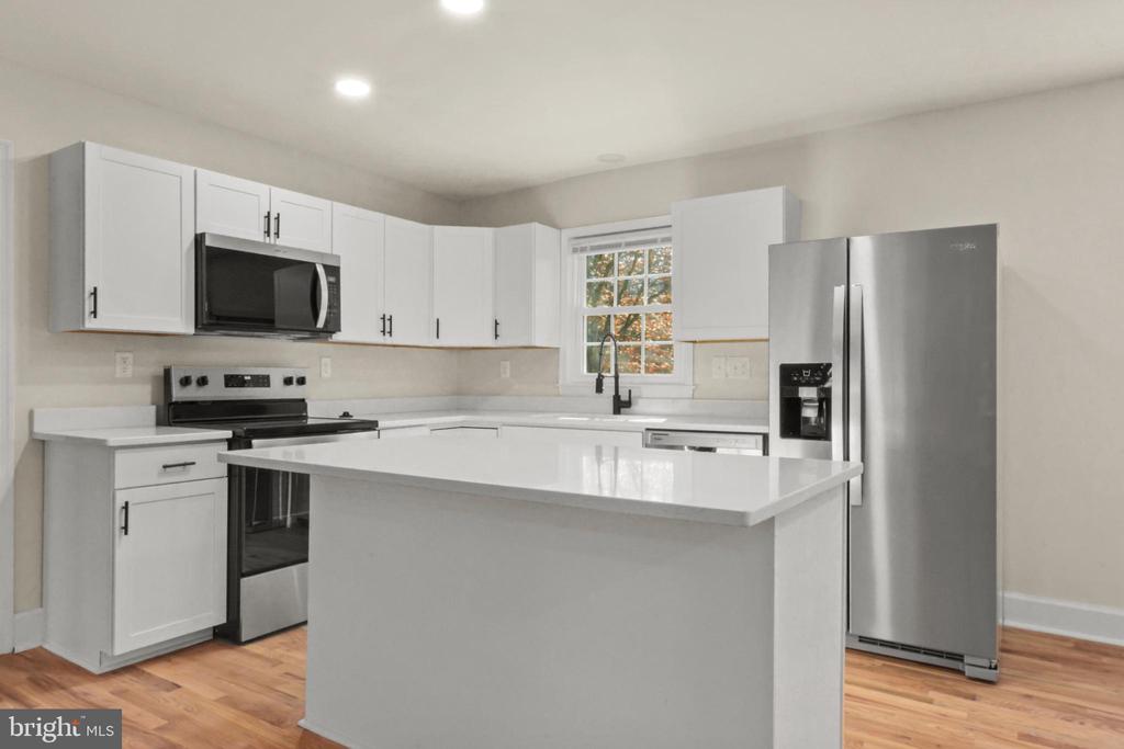 Welcome to this beautifully updated 3-bedroom, 3-bath home located in the heart of Crozet. Offering approximately 2,448 sq. ft. of living space on a generous 0.41-acre lot, this property combines modern updates with classic charm. The home features an updated kitchen with stainless steel appliances, new hardwood floors, new HVAC, siding, windows, and doors. Enjoy relaxing on the covered front porch or entertaining on the spacious back deck. Inside, you'll find a cozy fireplace on both the main level and in the walkout basement (both as-is), providing warmth and character throughout. Conveniently situated near schools, parks, and local shops, this move-in ready home is a wonderful opportunity to enjoy Crozet living at its best. Schedule your tour on showing time today!