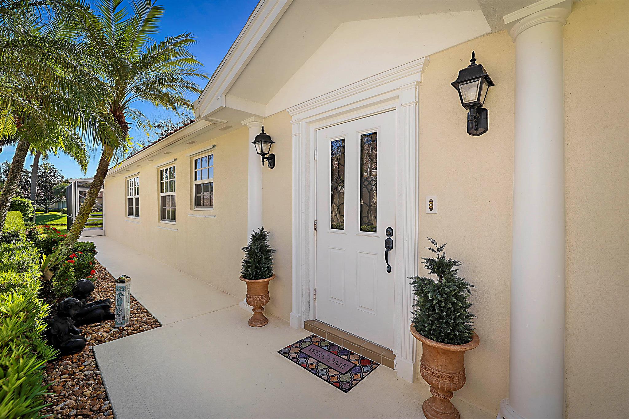 Most adorable 2 bedroom, 2 bath villa in The Isles community.  EVERYTHING has been updated!  The kitchen has custom built cabinets and have been extended into the dining area, double thick granite, decorative glass doors and stainless appliances.  The formal living room has a custom built wall unit with glass shelves, cabinets and built in TV.  Family room has gorgeous views out to the lake through impact French doors and plantation shutters.  The master bath was completely gutted and updated with custom built cabinets, granite counter tops, dual sink vanity, and walk in shower with etched glass.  Guest / 2nd bath, as well, was completely gutted and updated with a custom built vanity, granite, etched glass walk-in shower. This home has wood floors flowing throughout the entire place except tile in the bathrooms.  NO CARPET!  The laundry room has a sink, cabinet space, and storage closet.  This home has impact glass windows all around and also still has the hurricane panels for additional protection.  The garage has cabinet storage, epoxy floors and was painted a few years ago.   There are also pull-down attic stairs in the garage and the master bedroom closet for additional storage.   The Isles community offers a swimming pool, tennis, pickleball, and clubhouse.