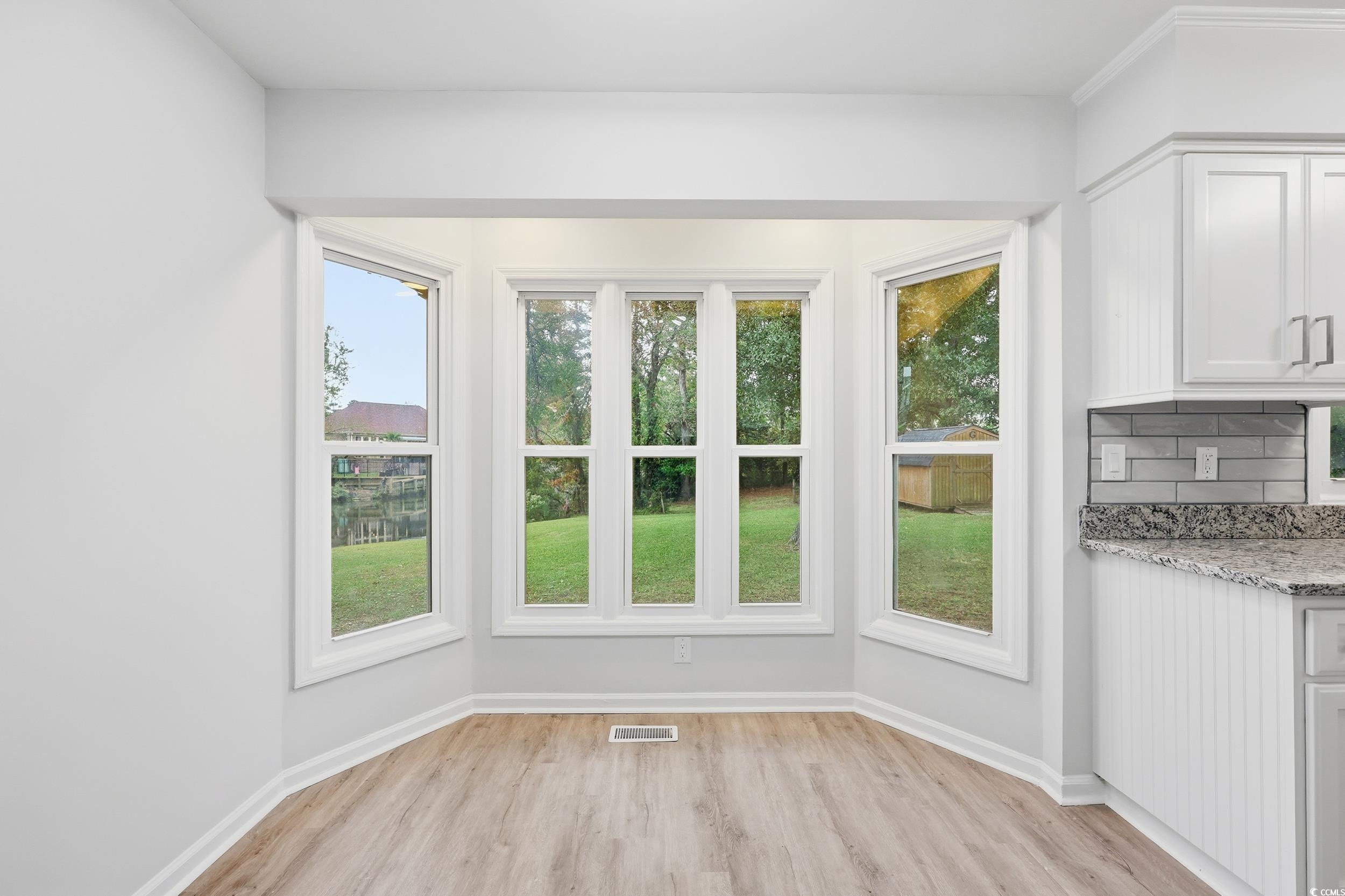 Interior space featuring wood finished floors and baseboards