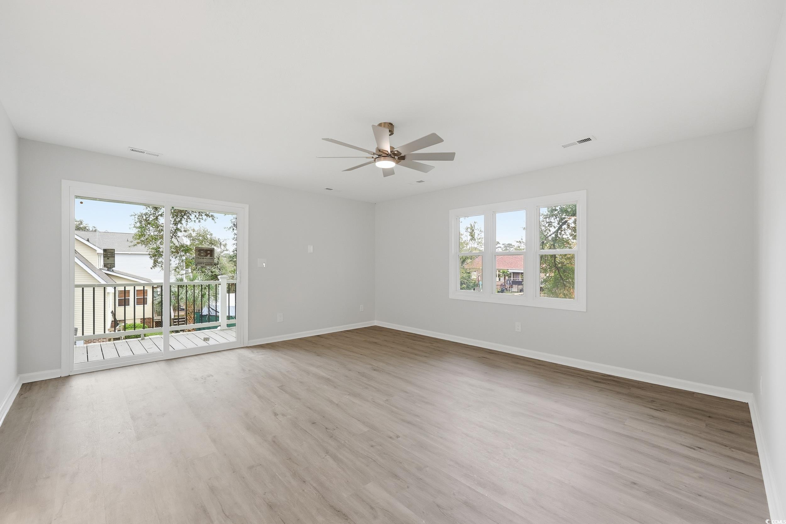 Unfurnished room featuring light wood-style floors and a ceiling fan