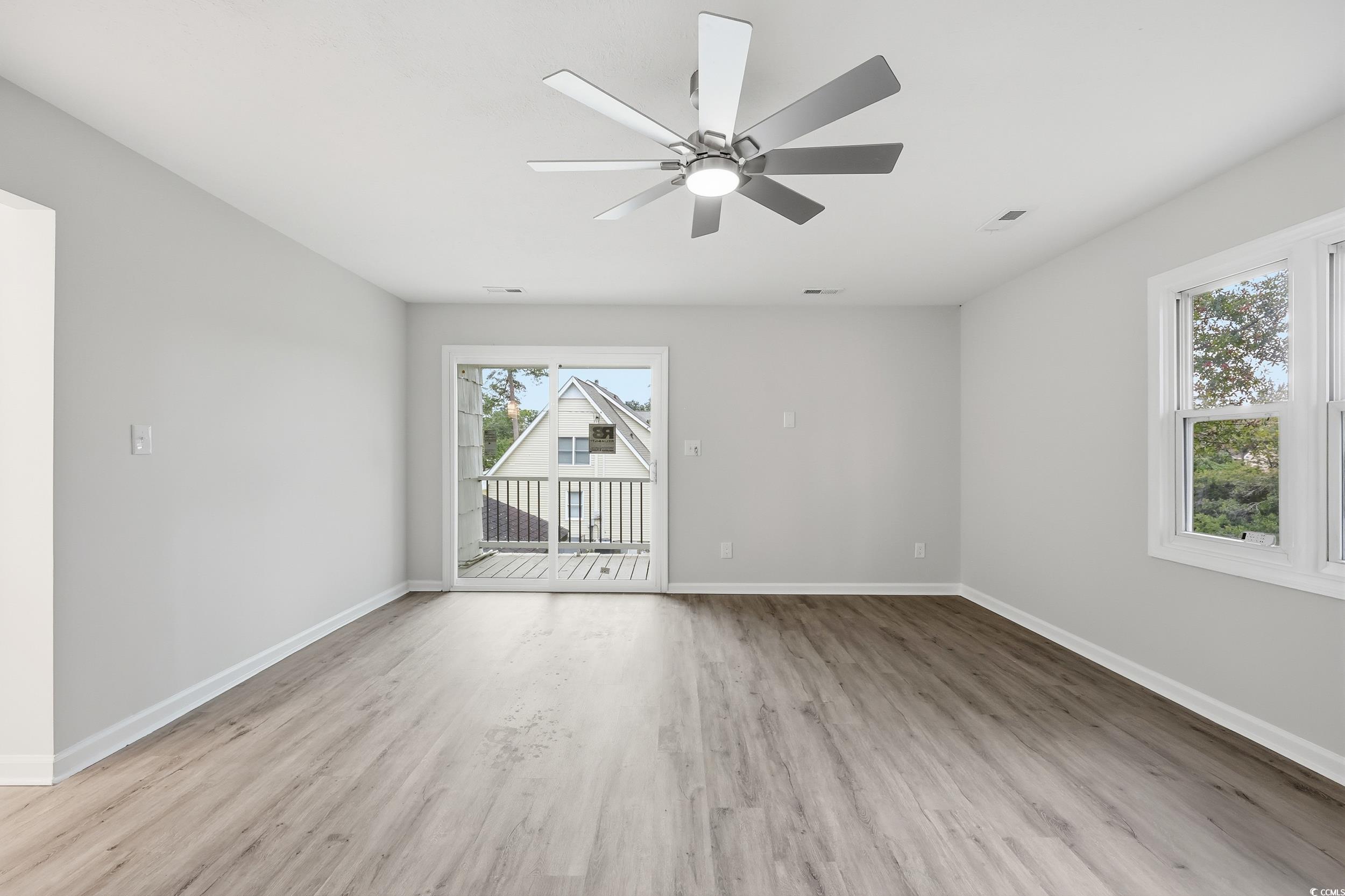 Spare room featuring light wood-style flooring and a ceiling fan