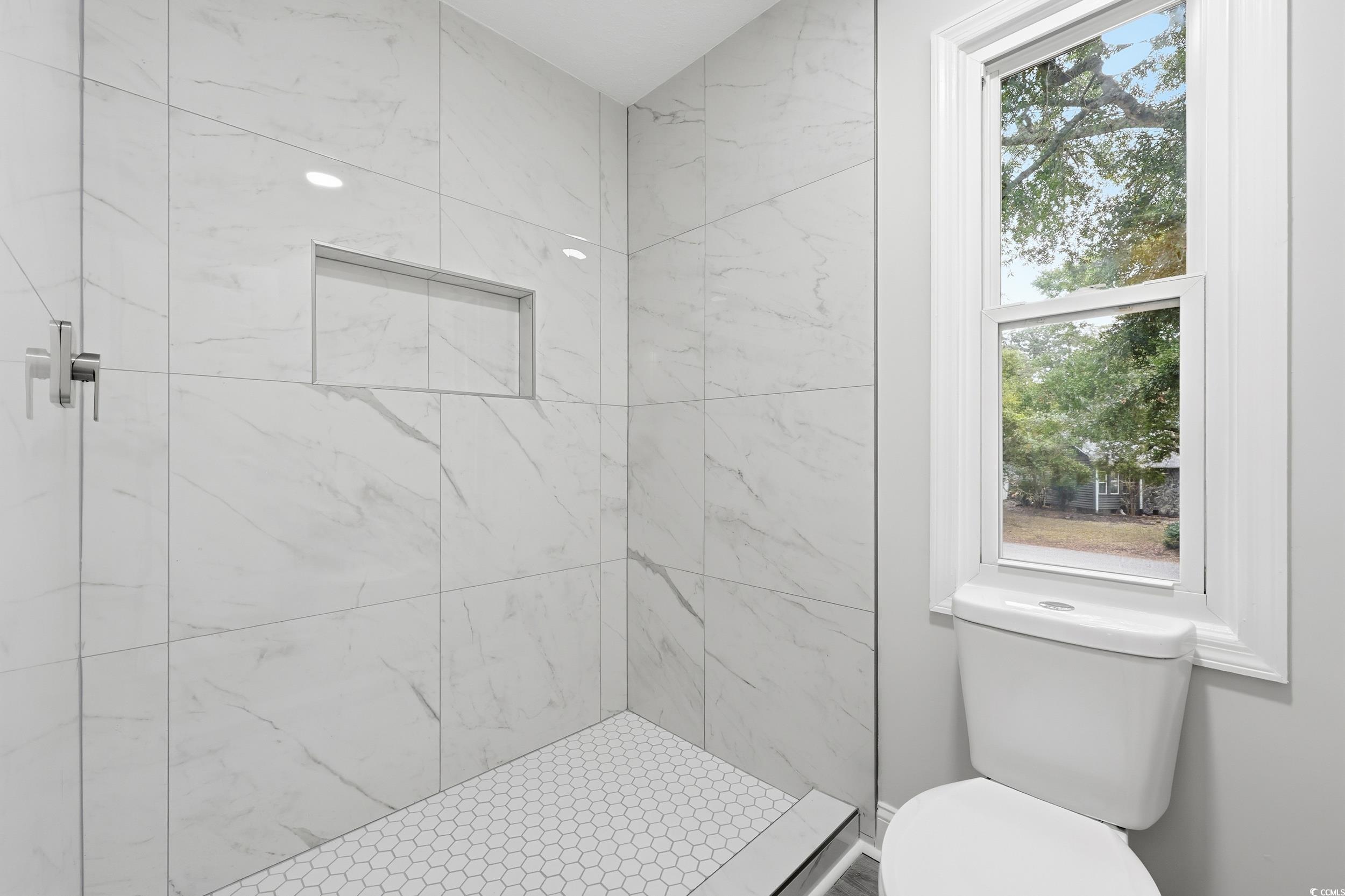 Bathroom with a stall shower and toilet