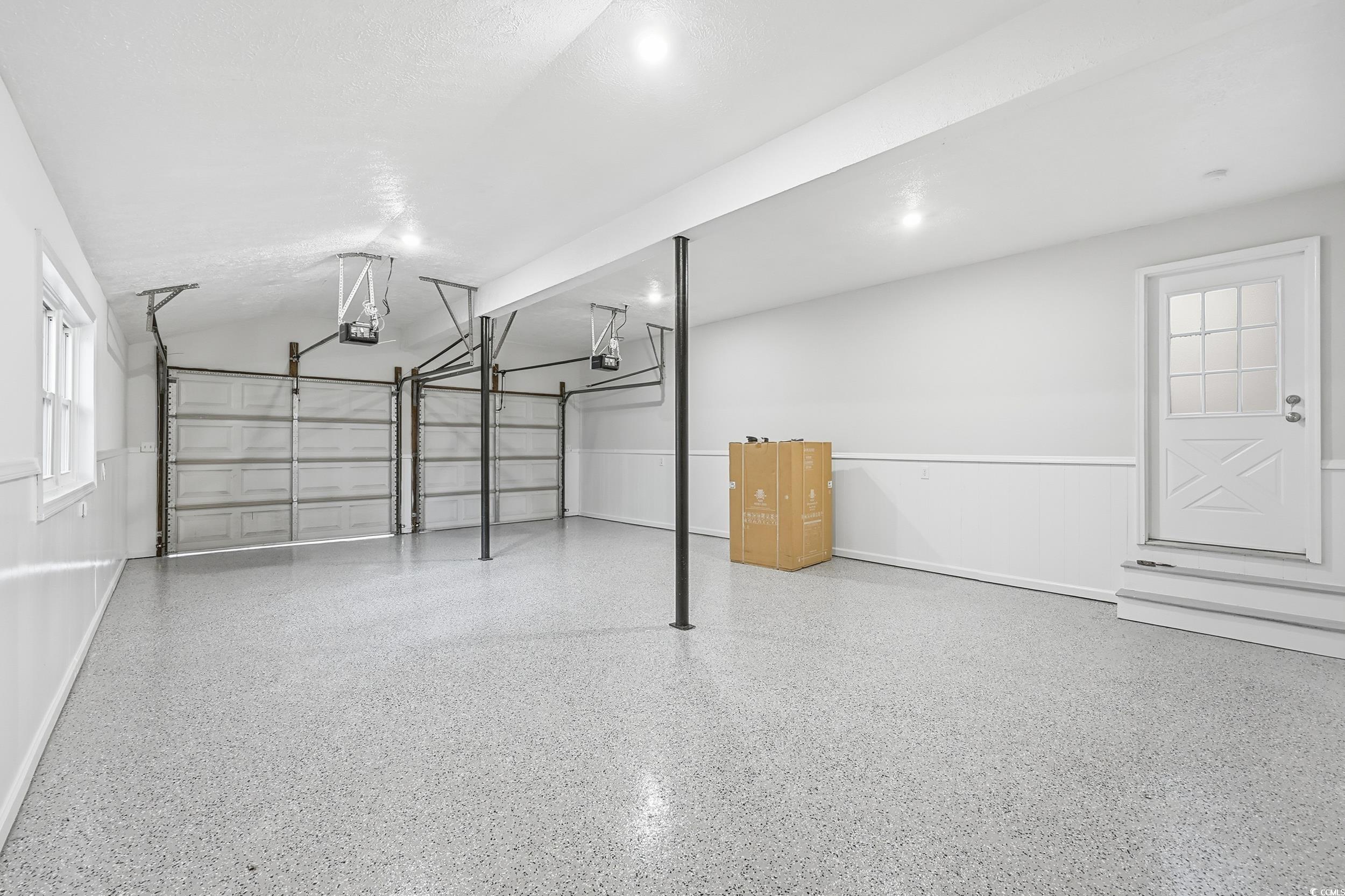 Garage featuring baseboards