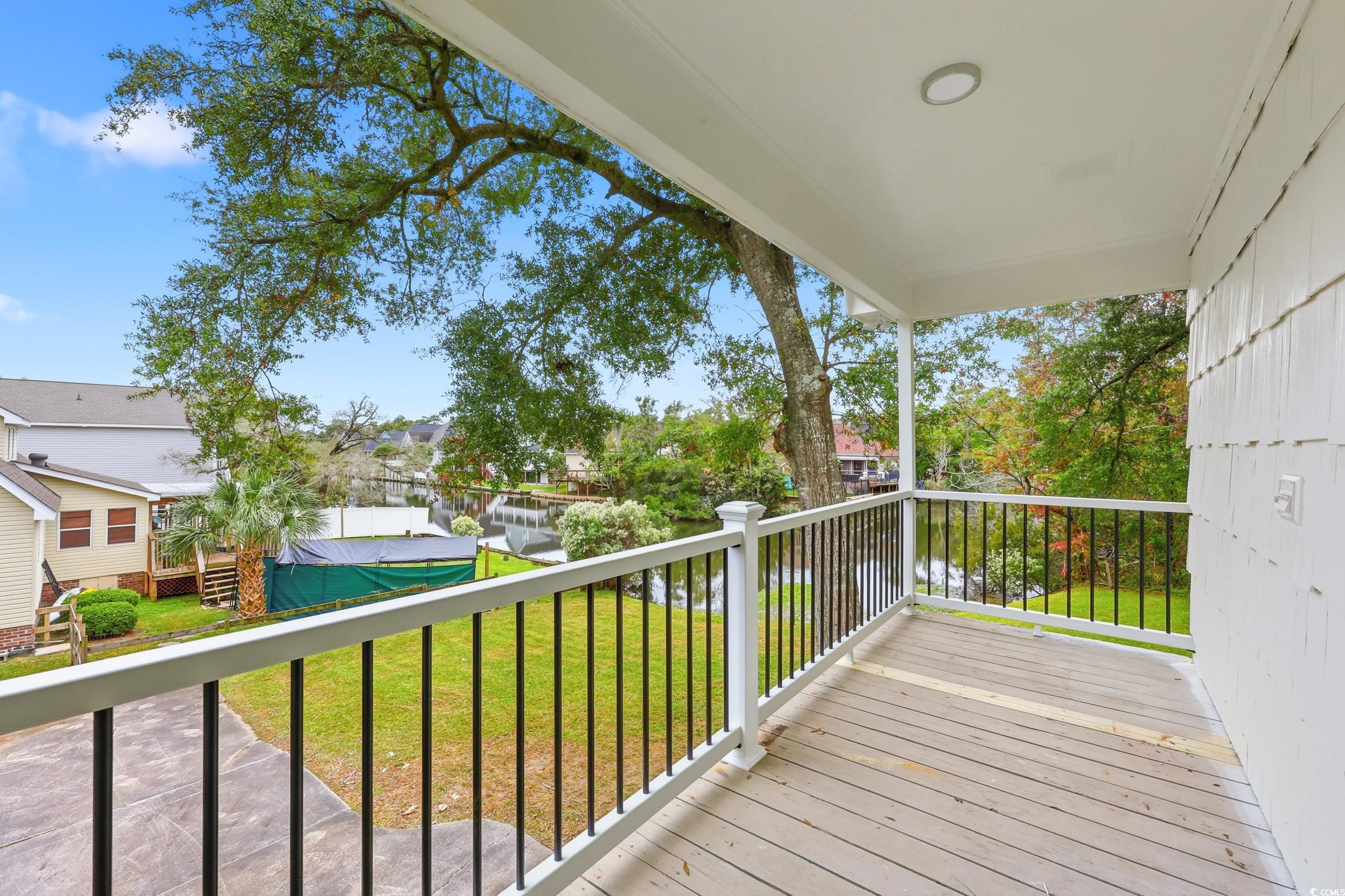 Deck featuring a lawn and a water view