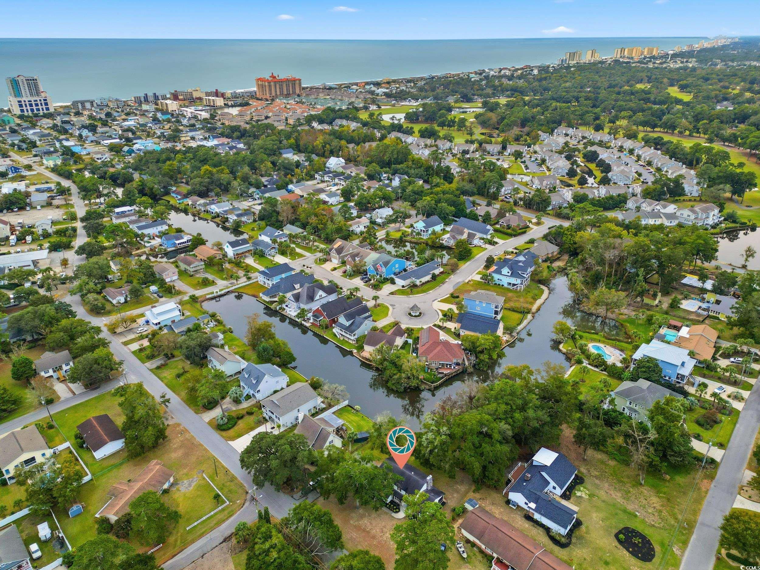 View of property location featuring a large body of water and nearby suburban area