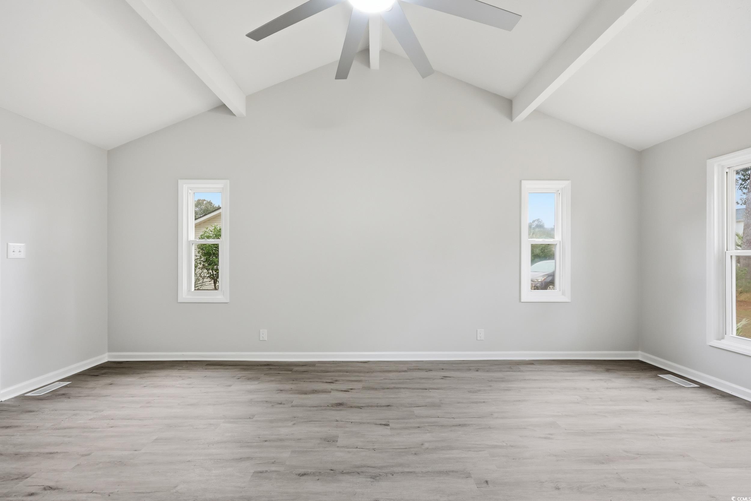 Empty room with light wood-style floors and baseboards