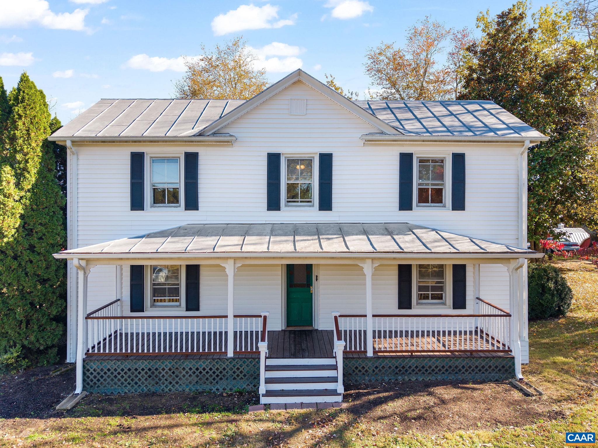 Nestled on a picturesque 2-acre lot in the rolling hills of Earlysville, this charming circa-1900 farmhouse blends historic character with thoughtful updates. Originally a four-room home, it later doubled in size with a two-story front addition. Enjoy relaxing on the inviting front porch while taking in breathtaking sunsets. Inside, a welcoming foyer opens to a spacious living room and main-level primary bedroom. The large dining room and flexible study or guest room lead to a nicely renovated kitchen with a generous island, stainless steel double wall oven, lots of cabinets and access to a sunroom overlooking the scenic backyard and patio. Upstairs are two spacious bedrooms and unfinished attic space with potential for another bath or bedroom. Several awesome outbuildings offer great storage and workshop space - there’s so much to love about this peaceful country home. And great potential for updating even more!