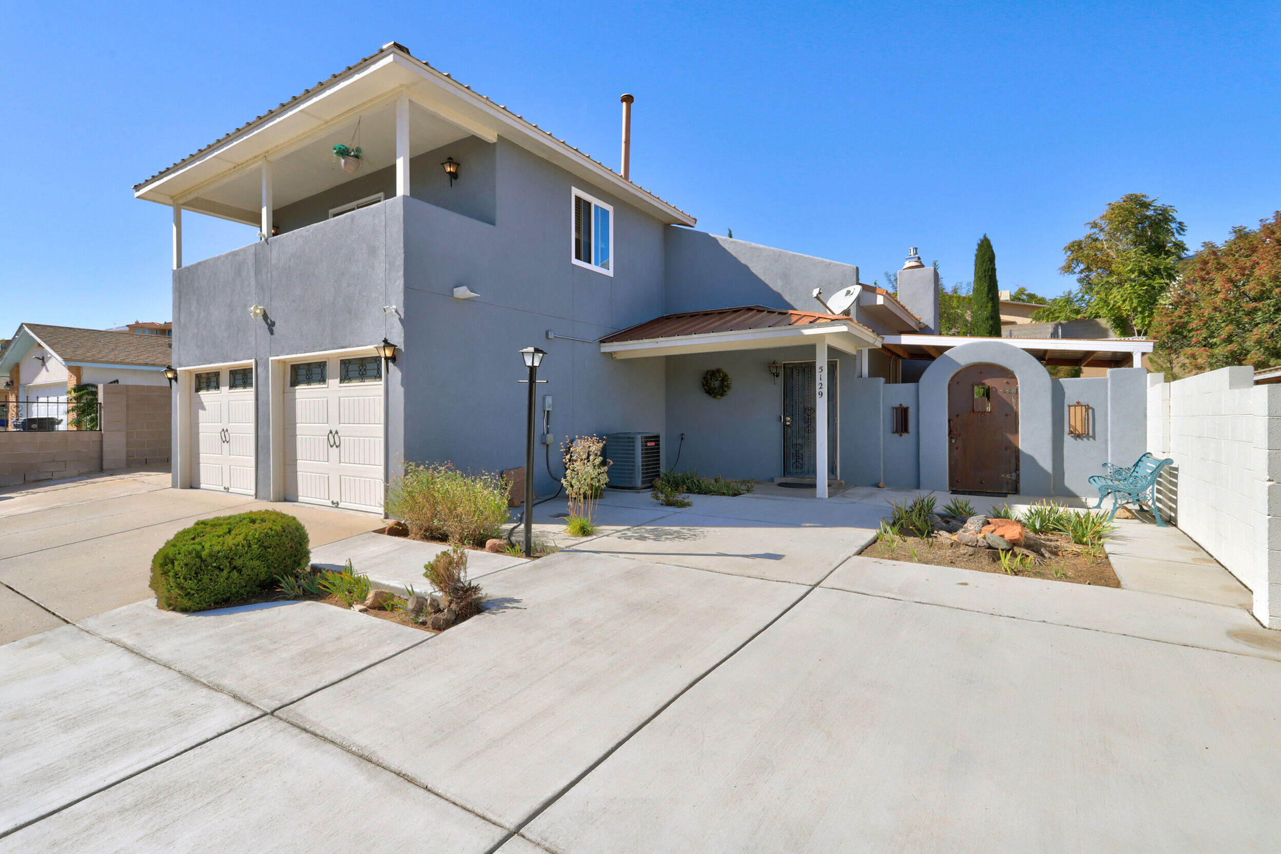 Welcome to this beautifully maintained 2-story, 3bed, 3bath home w/ a 2-car garage on a quiet cul-de-sac in a charming neighborhood, with easy access to Pat Hurley Park. This well-loved home boasts a metal roof, stucco, windows, water heater, laminate & tile flooring, granite countertops, & fresh paint updated within the last 5 years. Don't forget the views from the primary bedroom balcony of the Sandia Mountains, refrigerated air, & a beautiful gas fireplace serving as a centerpiece to your gathering space.  Enjoy a park-like backyard with a water feature, gazebo, storage shed, roses, lilac, honeysuckle, morning glory, daisies, sunflowers, iris, & easy-to-maintain turf. Complete this outdoor space with a covered back patio, hot tub area, RV pad, & carport.  This is a must see!
