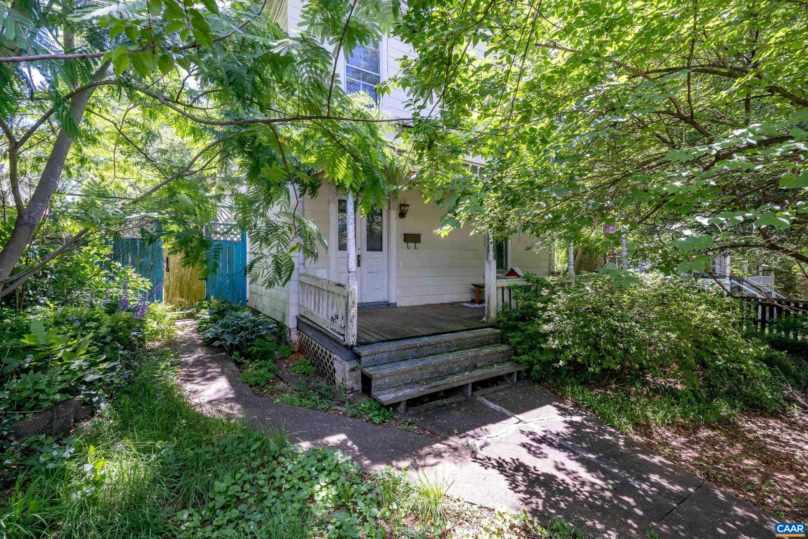 Historic Craftsman in Downtown Charlottesville – A Visionary’s Dream! Located in the highly sought-after Martha Jefferson neighborhood of Downtown Charlottesville with alley access, this historic Craftsman-style home is waiting to be reimagined! Just moments from restaurants, live music, coffee shops, and all the charm of downtown, this property is an incredible opportunity for those looking to create something special. Step inside to find soaring 10’ ceilings (remove paneling with potential for even more height!), grand foyer, expansive room sizes, solid hardwood floors and vintage sliding doors that once led to a parlor—a true nod to its historic character. The home also boasts a metal roof, a welcoming front porch, and a yard that was once fully fenced (partially fenced now) for added privacy. With tons of off-street parking via alley access and space to build your own garage, the potential here is endless! This property needs a total remodel, and the seller has no knowledge of its condition—bring your vision and your offers! Location. Character. Unlimited Possibilities. Don’t miss your chance to transform this historic gem! Sold as is.