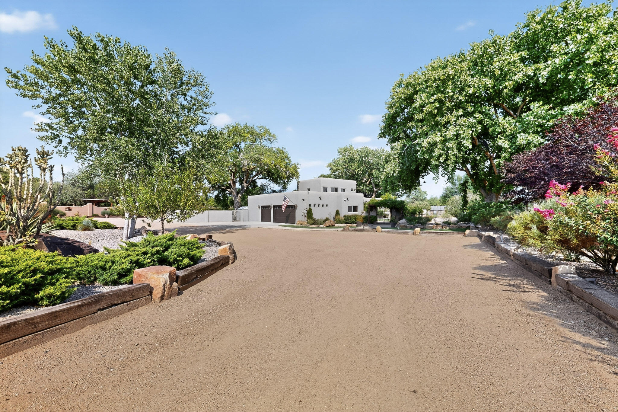 Stunning custom home in the Green Belt area  on a 1.47 Acre lush landscaped lot with irrigation access,  green house and dazzling features to include open concept custom kitchen (2022) with Quartzite countertops, stainless steel appliances, custom island with granite countertop, custom laundry room, updated bathrooms with beautiful tile and flagstone countertops, stained glass windows, Kiva Fireplace, Vigas, flagstone lined walkways and amazing landscaped yard with mature Cottonwood trees, outdoor fireplace, and large grass area perfect for parties and large gatherings! Fully fenced with electric gate entry, out of ground pool for summer time fun, Sprinkler System and Drippers! Refrigerated Air! 3 Car Garage plus Workshop Space! Front Courtyard fountain. Schedule a tour today!