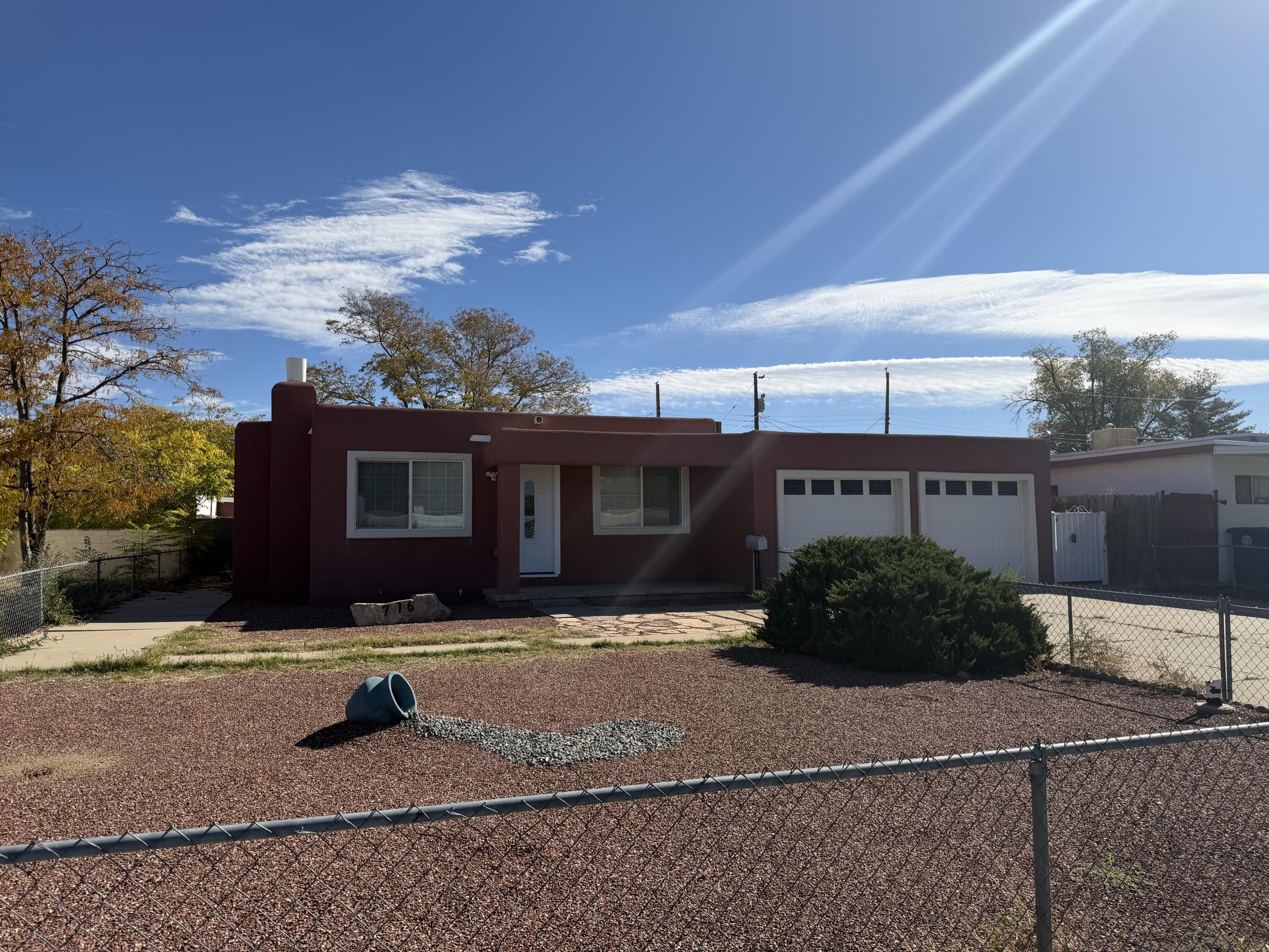 Beautifully updated 3 bedroom, 2 bath home in the heart of Albuquerque with a 2 car garage! This move-in ready property features a bright, open layout, stylishly remodeled kitchen with custom cabinetry and brand new stainless appliances. The spacious family room is framed by walls of sliding glass doors, seamlessly blending indoor and outdoor living. Enjoy abundant natural light and easy access to the backyard, perfect for entertaining or soaking up Albuquerque's beautiful weather year-round. The generous front and back yards offer plenty of room for outdoor living, entertaining, or future expansion. Conveniently located near shopping, dining, Kirtland Air Force Base, hospitals and easy freeway access, this home combines modern comfort with classic charm--ready for its next owner to enjoy!