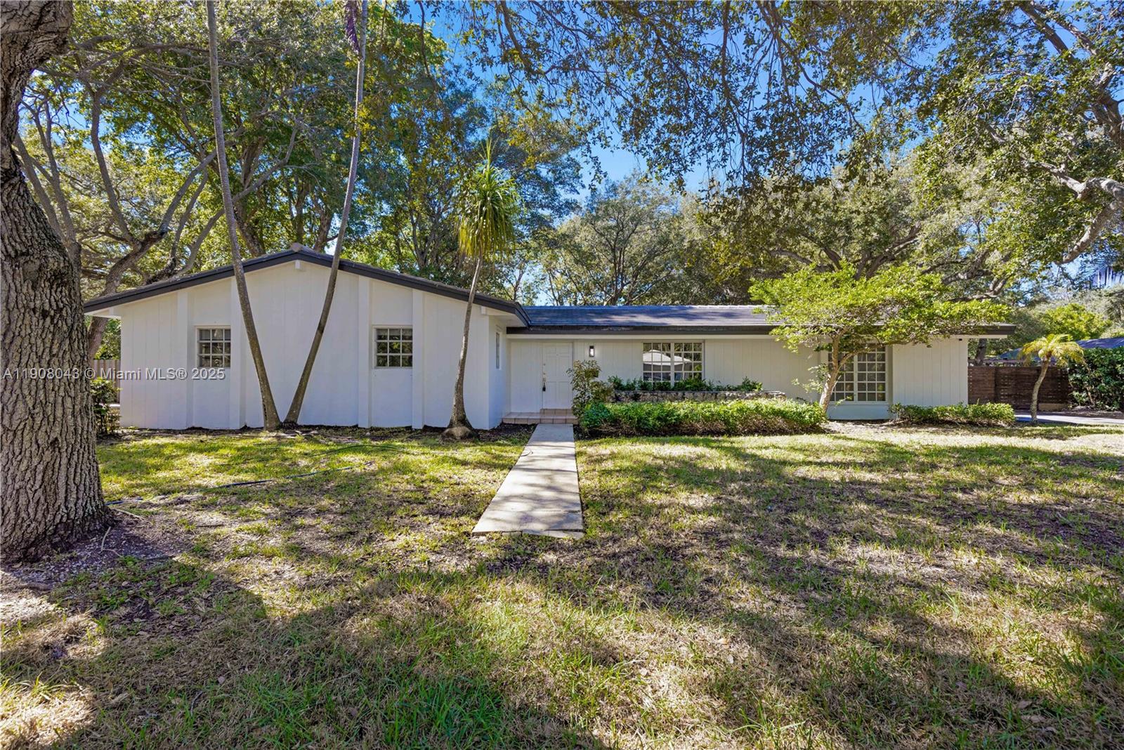 This charming 3-bedroom, 2-bathroom home is situated on a peaceful, tree-lined street in one of Palmetto Bay's most desirable neighborhoods. It features brand-new kitchen cabinets and appliances, formal living and dining areas, a spacious family room with coral rock accents, and French doors leading to a large backyard that's perfect for relaxing or entertaining. The primary suite includes a walk-in closet and private bath. The home has been freshly painted inside and out, creating a bright and inviting atmosphere. The fenced yard provides added privacy, while the oversized lot offers plenty of space for outdoor activities, mature trees for shade, and room for a boat or RV. It's conveniently located near top-rated schools, Coral Reef Park, and local shops.