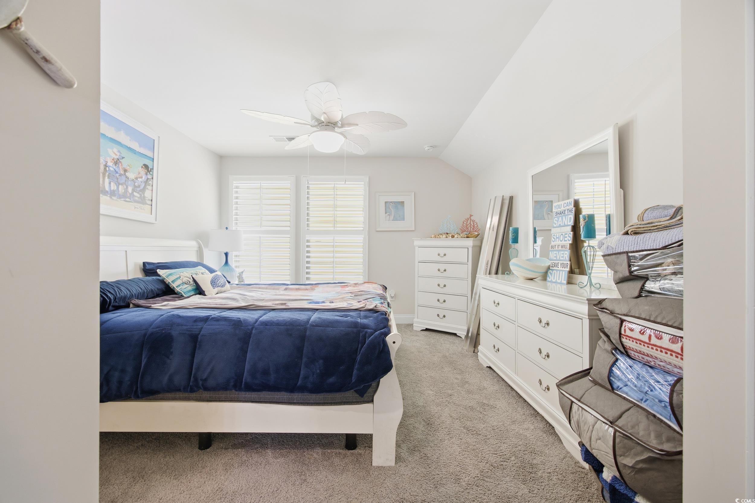 Bedroom featuring light carpet, a ceiling fan, and lofted ceiling