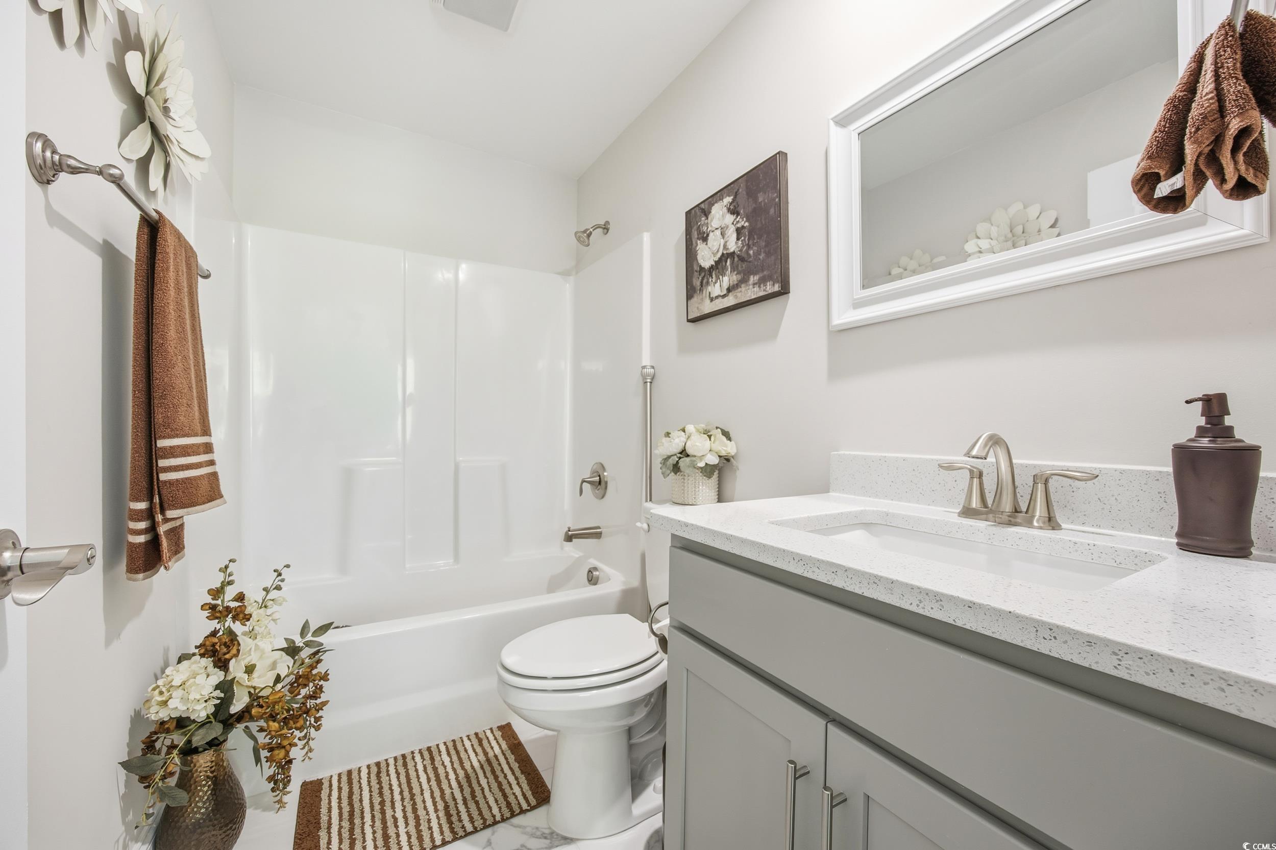 Full bath featuring tub / shower combination and vanity