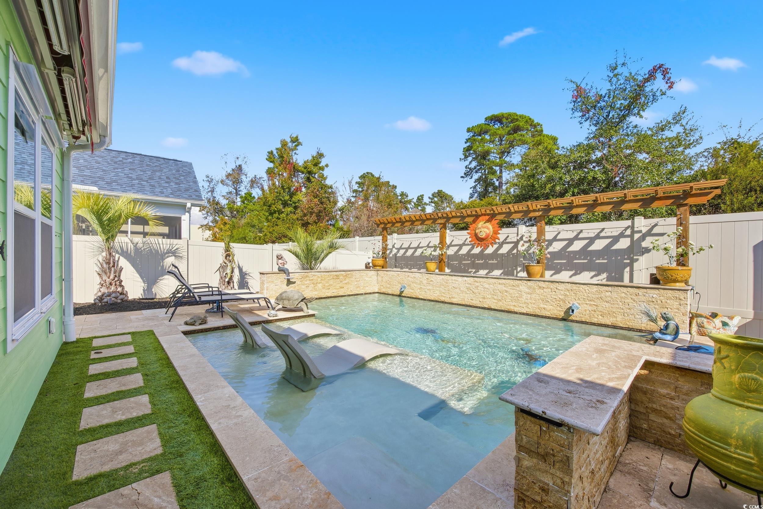 View of swimming pool with a patio area, a fenced backyard, and a pergola