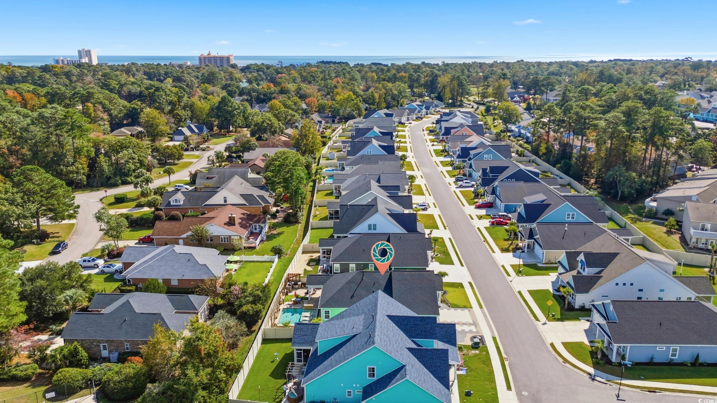 Aerial perspective of suburban area with a tree filled landscape