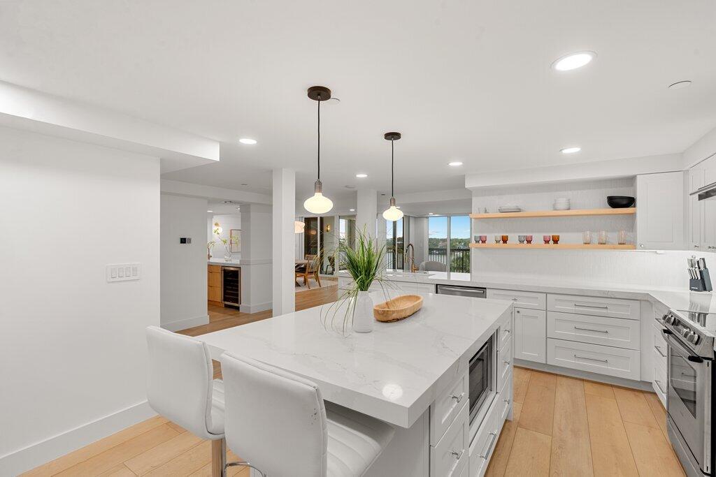 Breathtaking oceanfront/intracoastal 3BR/2.5BA, 3,025 sq ft residence--largest floor plan in the building--fully designer renovated in 2024 ($500K+). Features include new flooring, custom doors/windows, cabinetry, and a stunning kitchen with oversized quartz island and adjacent walk-in laundry. Bathrooms fully redone, plus wet bar with wine cooler. Enjoy panoramic Intracoastal and lighthouse views from living and primary suites. Oversized primary bedroom offers 4 closets (one walk-in) and a custom quartz office nook. New A/C, electrical, Bosch & Liebherr appliances. Two covered spaces near elevator plus private storage. Amenities: gym, meeting & game rooms, kayak/paddleboard storage, gazebo w/BBQ, swim-up dock, tennis, guest parking. All permits closed; assessments and restoration paid.