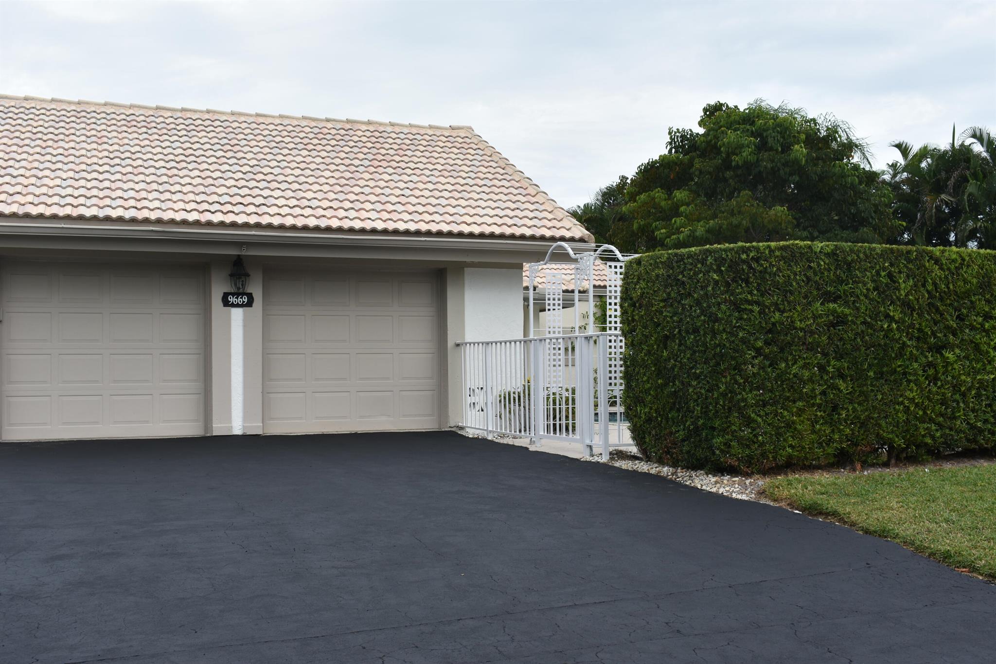 Rarely available amazing villa with 3-bedroom, 3 full bathrooms pool home with large yard in a secure guard gated community.  This home is situated on 1/3 of an acre.  The bedrooms are all spacious and have their own bathrooms. Master bedroom has 2 walk-in closets.  Kitchen and breakfast area overlook a garden atrium.  Skylights in the dining room and living room create an abundance of natural light for the home.  There is a large side yard and backyard.  Second garage is converted to a room, great for office/ playroom (has no ac) Association maintains lawn. Great schools, Whispering Pines Elementary is just outside the community. Close proximity to delicious restaurants and West Boca parks.  SELLER WELCOMES A QUICK CLOSING