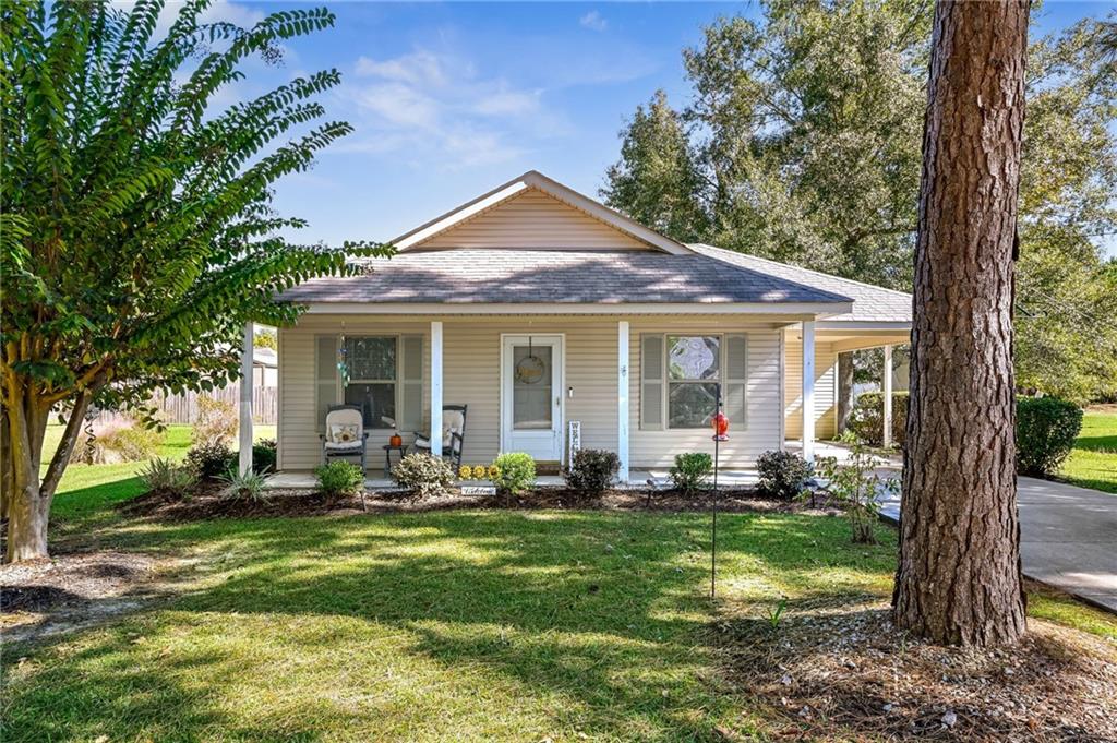 This adorable, well-kept home is tucked away on a peaceful cul-de-sac and offers a beautiful pond view.  Step inside to a cozy living area filled with lots of natural light!  Plenty of cabinets and room in the kitchen & dining area to cook and gather at the table. The home features 2 comfortable bedrooms and one full bath, with an oversized walk-in closet in the primary bedroom.  Enjoy your mornings & evenings sitting on the inviting front porch, or unwind on the rear deck while soaking in the peace and quiet.  This property has great curb appeal, a nicely landscaped yard and a carport for convenient parking, with an outdoor storage room.  Located in town, this home offers both tranquility and accessibility.  You will not want to miss this one!