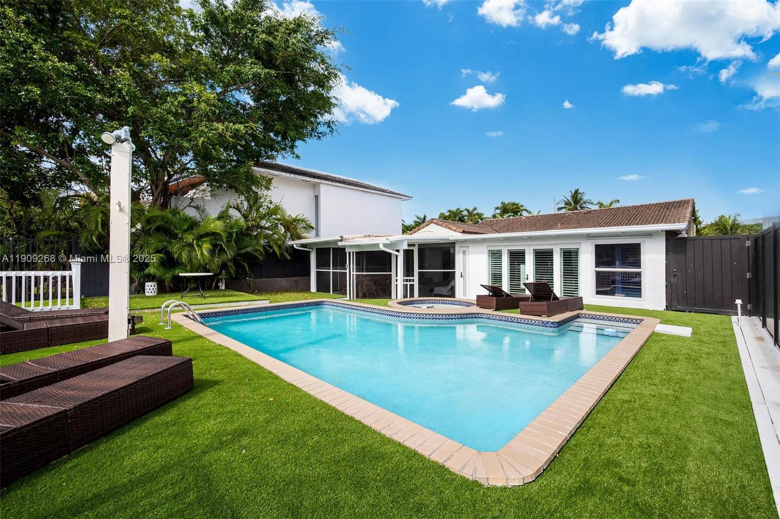 Belle Meade waterfront—deep canal with direct access to Biscayne Bay and the ocean. Remodeled 4BR/2BA with high exposed-wood ceilings, gourmet kitchen, and wide water/garden views. Outdoor living shines: screened porch, expansive deck, pool, spa, and lush landscaping. Approx. 50 ft of frontage with full dock. Set inside a 24-hr guarded, historic gated enclave offering rare privacy and tropical surroundings, minutes to the Design District, Downtown, and beaches. Surrounded by new construction—strong upside and rental potential. Easy to show.