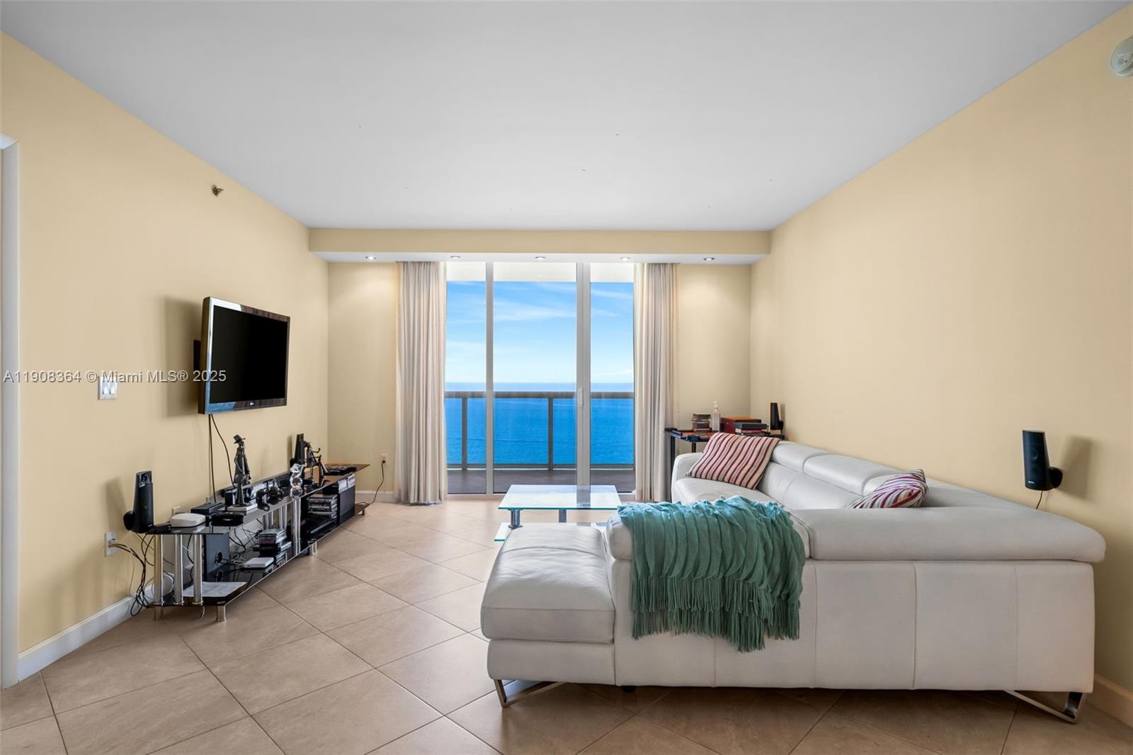 This luxurious beachfront unit features two bedrooms plus a den, which can be converted into a third bedroom or office, along with three full baths. The spacious layout includes walk-in closets and a gourmet kitchen equipped with KitchenAid appliances. The master bath provides a spa-like experience, complete with a Jacuzzi tub, dual sinks, a separate shower, and a bidet. Residents can enjoy fantastic amenities, including three heated pools, a spa, 24-hour valet and security services, and a 28,000 sq ft fitness center with stunning ocean views.