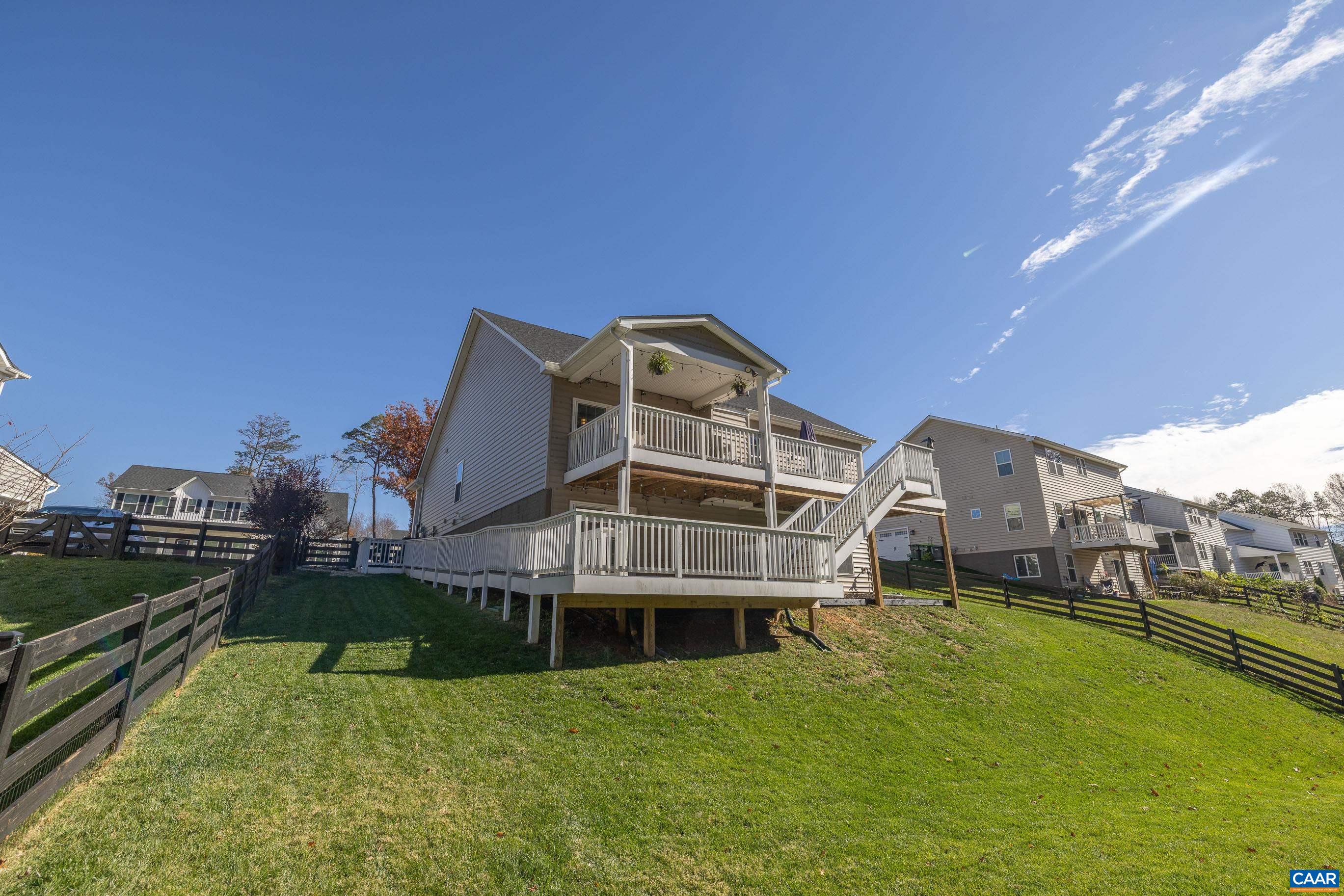 Open House - 11/9 from 1 to 3 -- 5227 Sparrow Hill Lane combines one level living, peace, accessibility, and modern comfort in the heart of Crozet. Built in 2020, this 3-bedroom, 3-bath home offers an open floor plan with 9' ceilings, luxury vinyl flooring, and a gas fireplace. The bright kitchen features granite counters and stainless appliances, opening to a spacious living area with access to upper and lower decks overlooking a private, wooded backdrop. The walk-out basement includes a rec room, guest suite, and full bath. Recent upgrades include a high-efficiency tankless water heater, new flooring downstairs, new paint throughout, and a fenced rear yard. Enjoy quiet neighborhood strolls with no through traffic and quick access to Crozet’s shops, dining, and top-rated schools—Brownsville, Henley, and Western Albemarle. HOA covers area maintenance. Convenient to I-64, downtown Charlottesville, and nearby trails and parks.