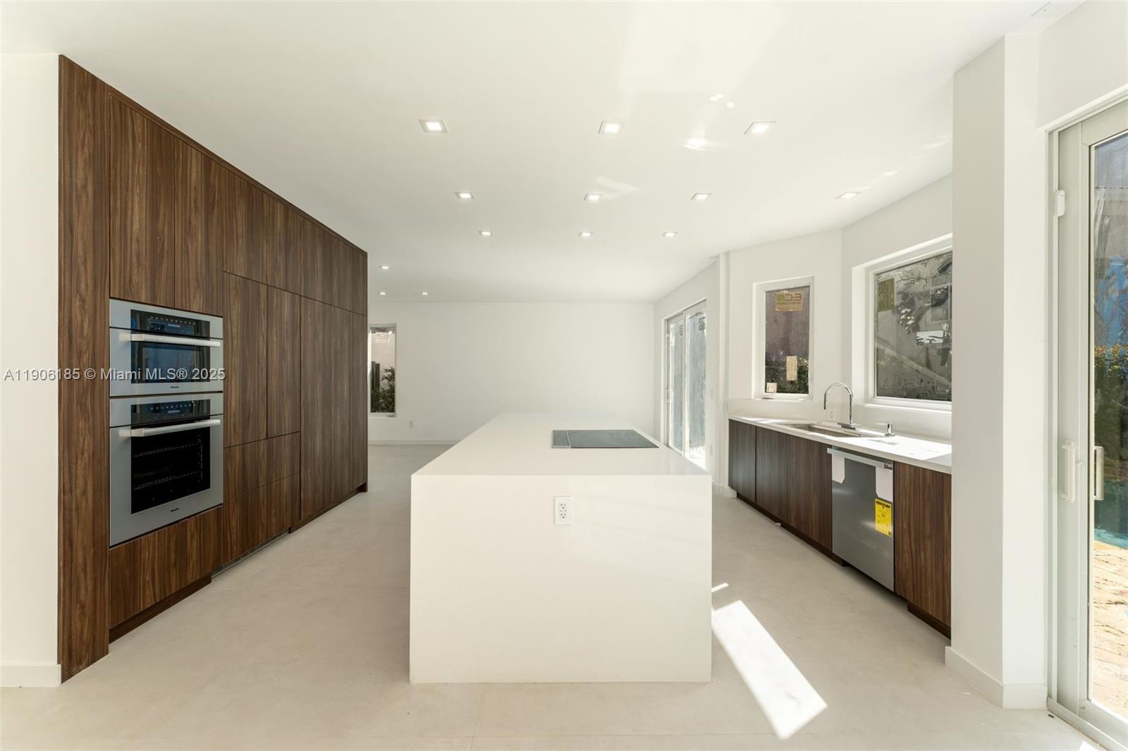 Beautifully renovated 5-bed, 5.5-bath residence in the exclusive gated community of Golden Gate Estates in Sunny Isles Beach. Sophisticated interiors feature soaring ceilings, designer finishes, and a gourmet kitchen opening to bright living spaces. The primary suite overlooks a private tropical backyard with sparkling pool and lounge area—perfect for entertaining or relaxing. Enjoy a 2-car garage, 24-hr security, tennis, and playground. Walk to the beach and minutes from Aventura Mall and Bal Harbour Shops.