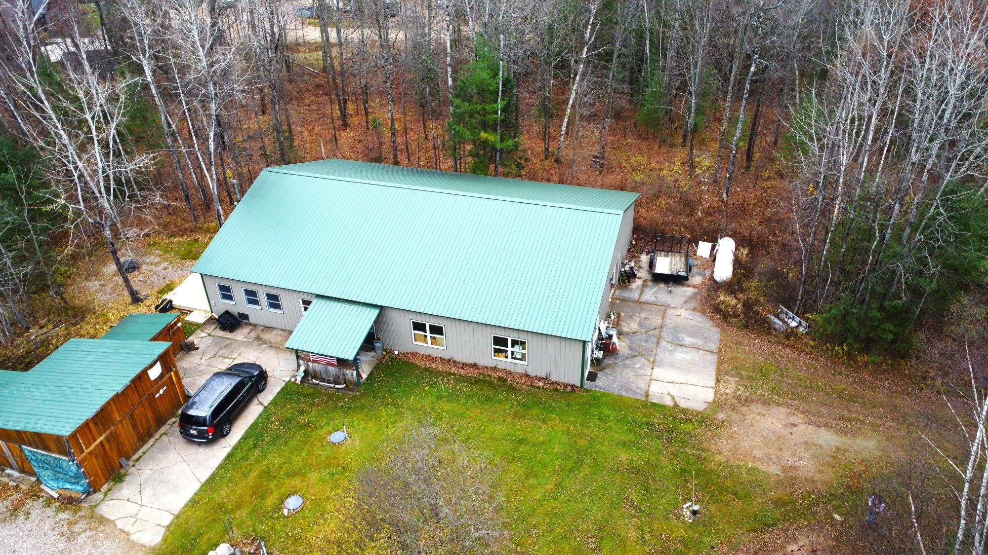 Spacious 3,500 sq. ft. barndominium on 3 acres, featuring 1350 sq. ft. of comfortable living space with hardwood throughout, 2 bedrooms and 1 bath. Enjoy a 36x50 heated garage—perfect for projects or storage—and an additional 10x50 storage area for all your gear and tools. Ideal location with direct access to UTV and snowmobile trails, offering endless outdoor adventure right from your doorstep. Plenty of room to spread out, relax, and enjoy country living at its best! Call today to set up showing. All data approximate, Buyer to verify all information.