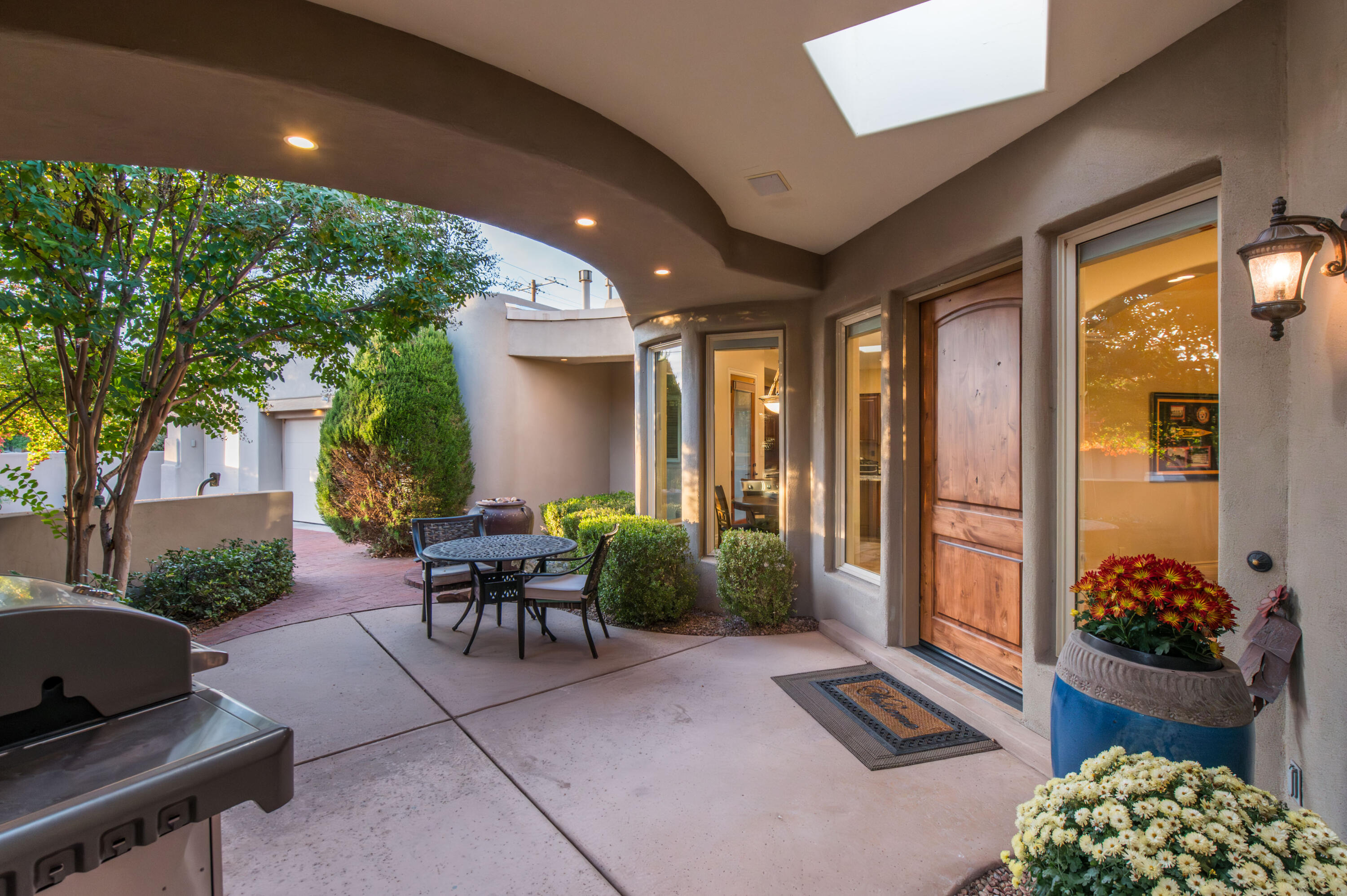 Located in the beautiful North Valley near miles of ditch trails, the Bosque, the Co-op, downtown, Old town and 15 minutes from UNM but a world away. Luxurious single story plan w/high ceilings. natural light & interesting architectural details. 3 bedrooms, each with a bath, in main home plus a sweet guest suite with bath across the courtyard.  Elegant great room with neutral tile flooring, raised ceiling, gorgeous stone fireplace and door to beautifully landscaped rear yard and patio.  Cook's kitchen with so much counter space including TWO islands! 5 burner gas range. Pantry.  Spacious primary in its own wing with en suite bath with custom shower, sep tub, double sink and large walk-in.  Step out to the rear yard on lovely evenings from primary bdrm patio door.  3 car gar w/sink.