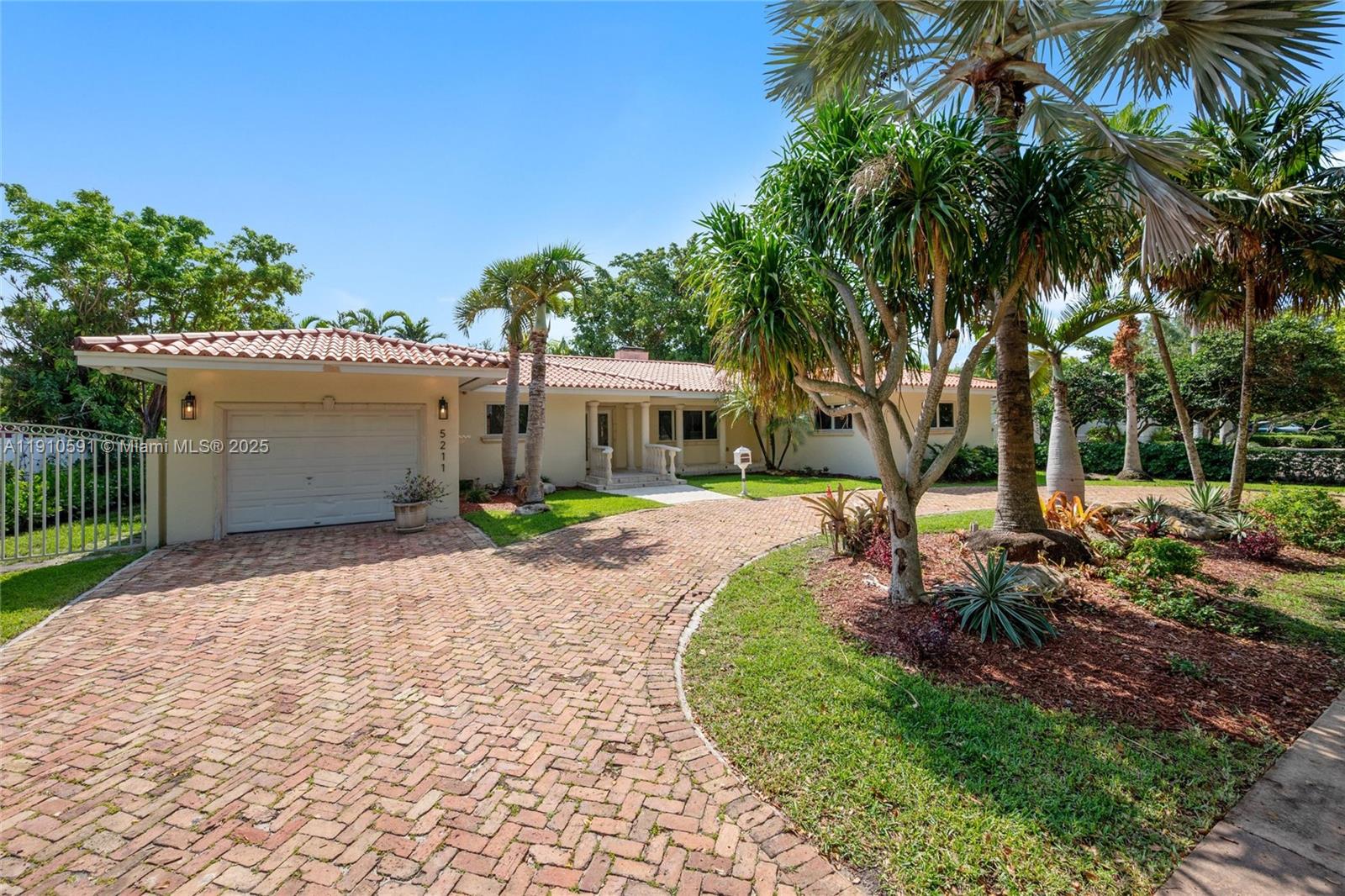 Located on one of the most desirable streets, this beautifully maintained home offers 2,415 square feet of comfortable living space on an expansive 11,382 sq. ft. lot. The property features four generously sized bedrooms and three full bathrooms, including a spacious primary suite with a private en-suite bath and ample closet space in every room. The inviting living room boasts a charming wood-burning fireplace, while rich wood and porcelain flooring flow seamlessly throughout the home. A bright and open-concept kitchen connects to the formal dining area and a cozy breakfast nook, all overlooking a large, wood-beam covered terrace—perfect for outdoor dining and entertaining. The terrace includes a built-in barbecue and opens to a lush, grassy backyard with plenty of room for a pool.