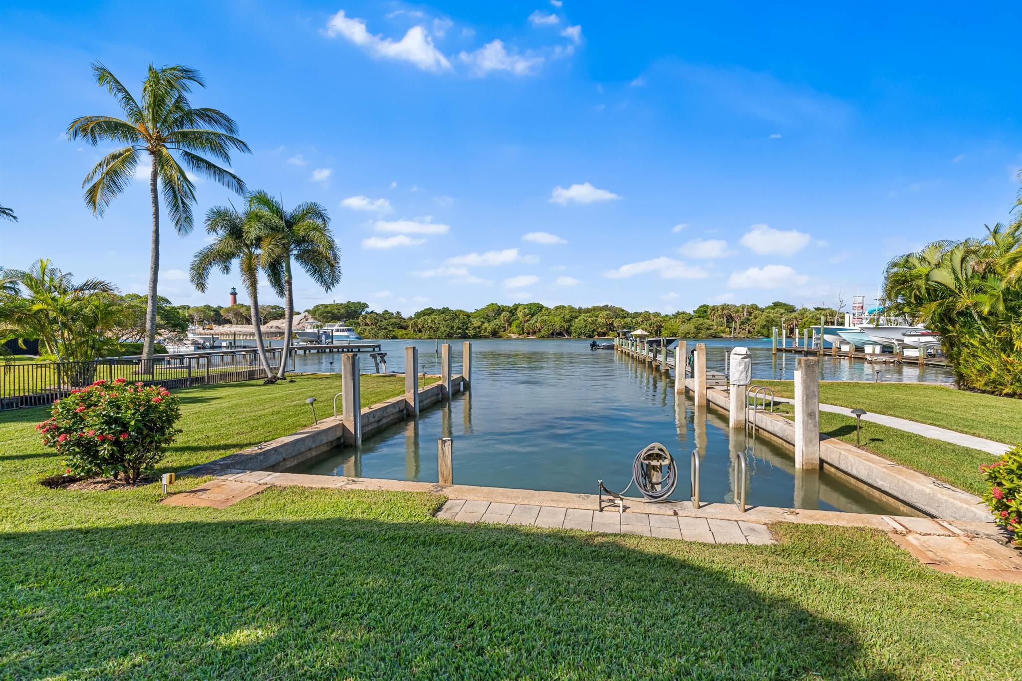 In the heart of Jupiter where coastal breezes carry decades of tradition, enjoy the Ultimate South Florida Lifestyle w/100 FEET of DIRECT INTRACOASTAL frontage in your backyard plus access to charming pathways that lead to the PRIVATE BEACHES of Jupiter Inlet Colony.   The turquoise waters are yours with private dock + basin to explore boating, snorkeling, fishing and simply watching the manatees, birds, and sea life. The open + light design offers spectacular SUNSET views overlooking the Intracoastal, the iconic Jupiter Lighthouse + Natural Area. This spacious 4-bedroom home features metal roof, large screened lanai w/pool, special architectural details, wonderful gathering spaces inside + out, plus a mature landscape w/avocado tree + mini banana grove on almost 1/2 an ACRE to give that you are looking for a classic escape or a foundation to build your dream home, this coveted location offers easy living just moments from dining, shops, and golf accessible by boat, car, or bike.  PBl Airport, Palm Beach, West Palm Beach being approx. 30 minutes away keeps you seamlessly connected to all that this remarkable South Florida region has to offer.