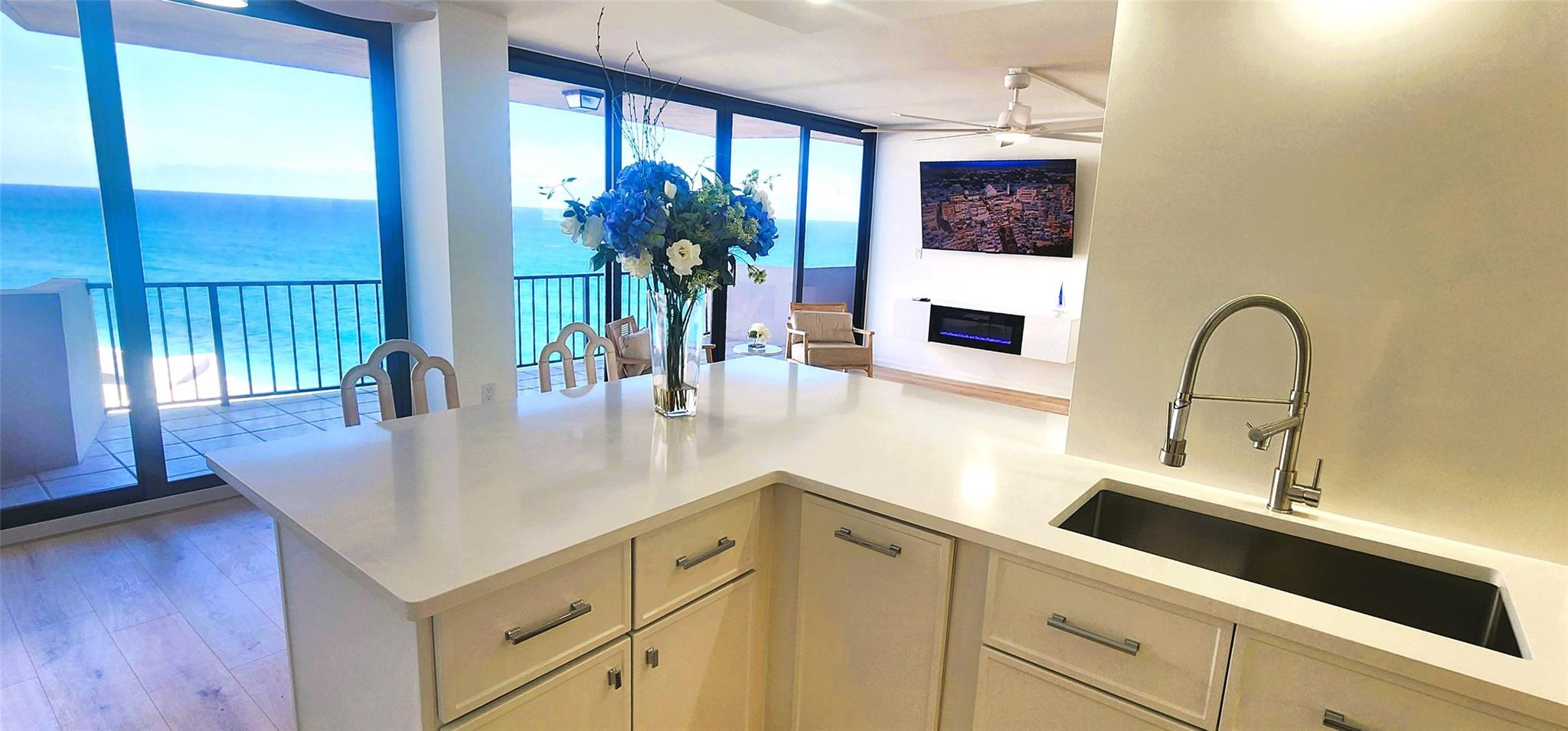 Impact sliders will be installed in December, and the entire building will feature impact glass by January 2026. This residence offers water views from every room, providing an exceptional Singer Island living experience. The condo showcases a meticulously upgraded interior with elegant finishes and an open layout designed to maximize natural light and highlight ocean vistas. Private balconies overlook the Atlantic, perfect for enjoying morning coffee or evening breezes. The property is move-in ready and includes a wall-mounted TV; furniture is excluded. Residents have access to resort-style amenities including a heated pool, fitness center, secure parking. The complex has no assessments, and maintains strong financial reserves for added peace of mind.