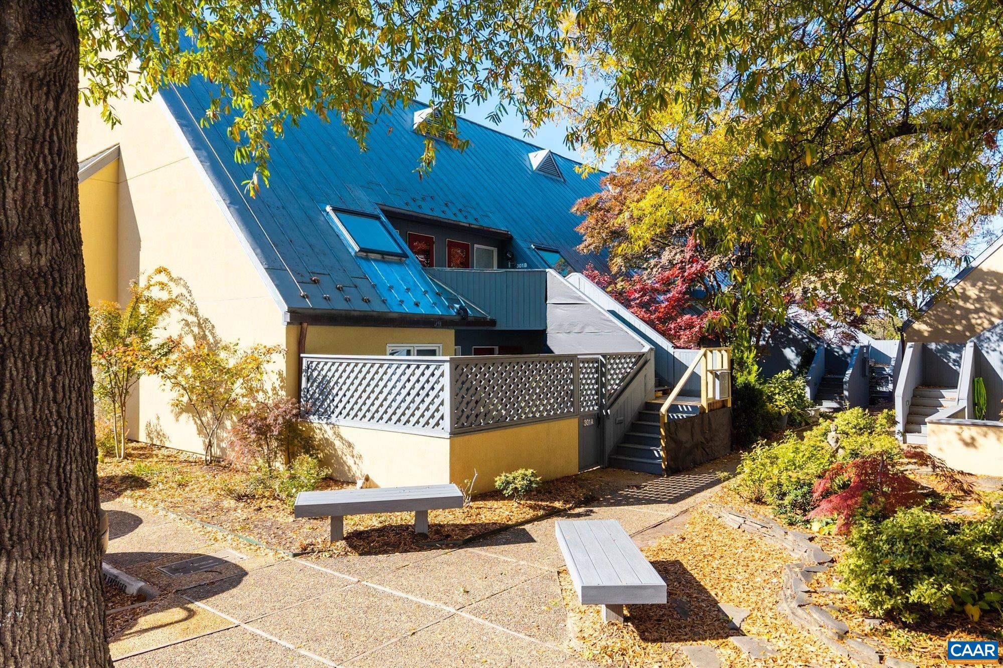 Just steps from Charlottesville’s Downtown Mall, this light-filled end-unit condo offers convenience, privacy, and charm in an unbeatable location. McGuffey Park and the McGuffey Art Center are right around the corner, and you’ll be moments away from local restaurants, live music, galleries, and boutique shopping.  Tucked in a quiet south-facing spot, the home features an open layout that brings in natural light throughout the day. The kitchen was thoughtfully redesigned by Karen Turner and opens to the main living area, complete with a fireplace and access to the first of two private decks. The second deck adjoins the primary bedroom upstairs.  The primary suite includes a tiled ensuite bath, in-unit laundry, and generous storage and closet space. A second bedroom works nicely as a guest room, home office, or studio. Additional storage is available in the 200 sq. ft. floored attic.  New hardwood floors throughout and a new picture window in the eat in kitchen. Two parking spaces are included, one of which is covered.