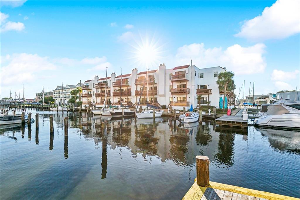 Welcome to peaceful waterfront living! Beautiful 2 bedroom, 2.5 bathroom waterfront townhome style condo with TWO gated and covered parking spaces. Enjoy expansive views of the marina and lake from all 3 balconies. Restaurants, grocery stores and plenty of other activities within walking distance of your front door. This unit is a must see!