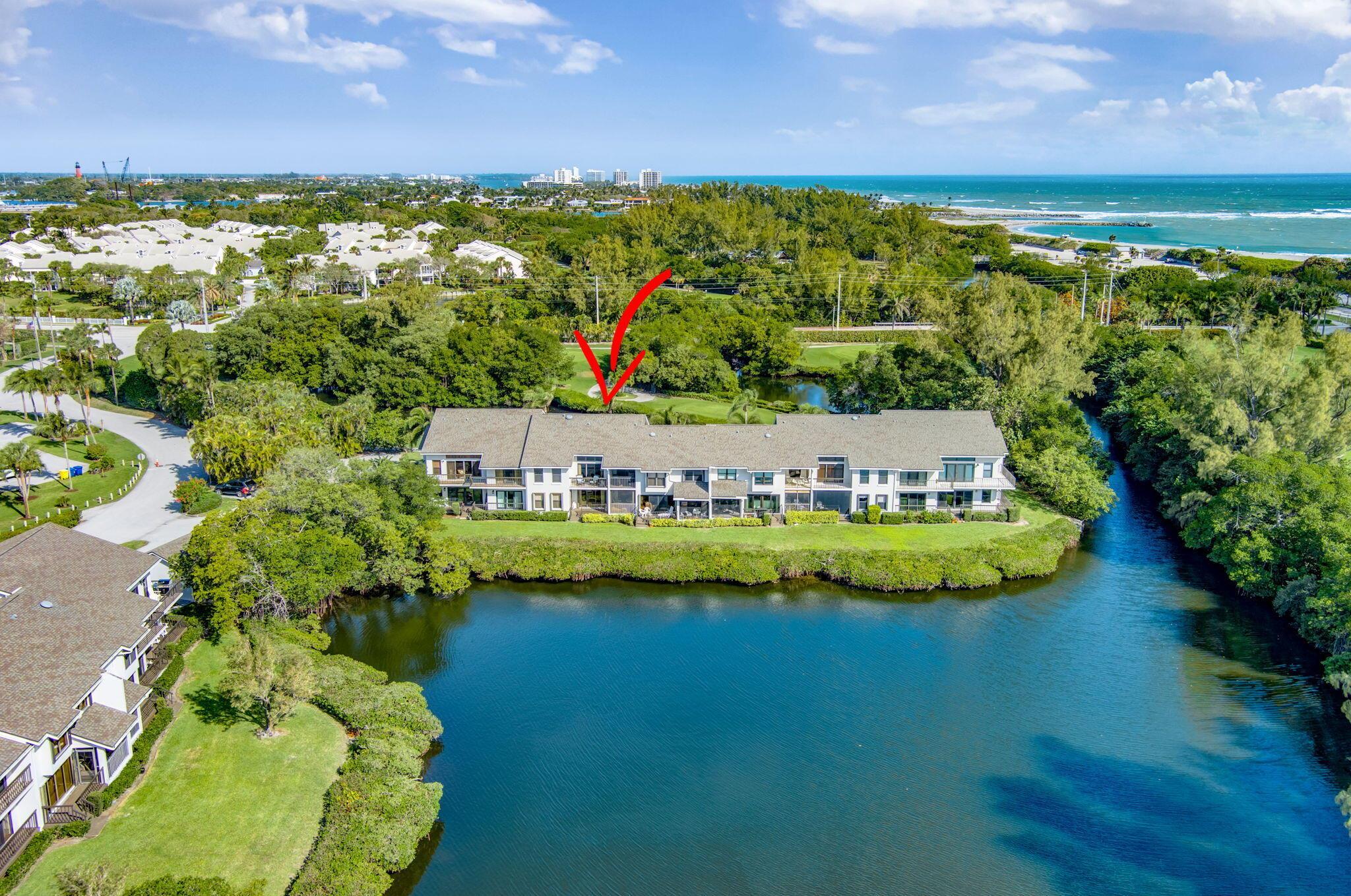 Absolutely amazing long water views of Jupiter's natural estuary from this beautifully renovated 2nd floor residence in the golf & beachside community of Jupiter Dunes. Surrounded by natural beauty, this home offers peaceful waterviews from all windows. Walk to the turquoise waters of Jupiter Beach, relax on the screened porch or sunny balcony & enjoy the sea breezes & the sounds of the ocean. Launch your kayak or paddleboard & cruise to the Jupiter Inlet. This special offering features: updated kitchen w/golf & water views; dining room; living room w/vaulted ceilings; primary suite w/French doors, walk-in closet & ensuite bath; guest suite w/golf views; screened porch, waterfront balcony & carport; new a/c & water heater. Located in Jupiter Inlet district-walk to waterfront restaurants!