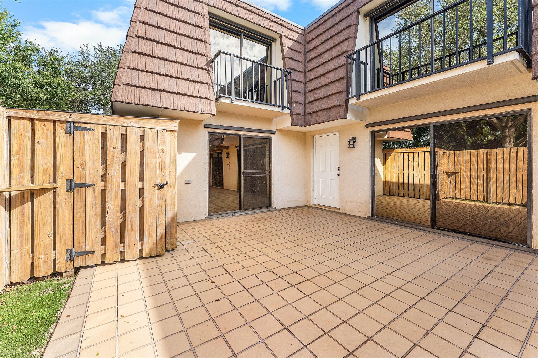 Don't miss the chance to own in the sought-after city of Palm Beach Gardens at a great value! This 2BR/2.5BA home with an additional office/den and spacious private patio offers peace and privacy. Upstairs features a large primary suite, guest bedroom, full bath, and private balconies off both rooms. The first floor includes a bright kitchen with stainless-steel appliances and a generous living area with a bonus room. Freshly painted inside and out. New roof 2025.