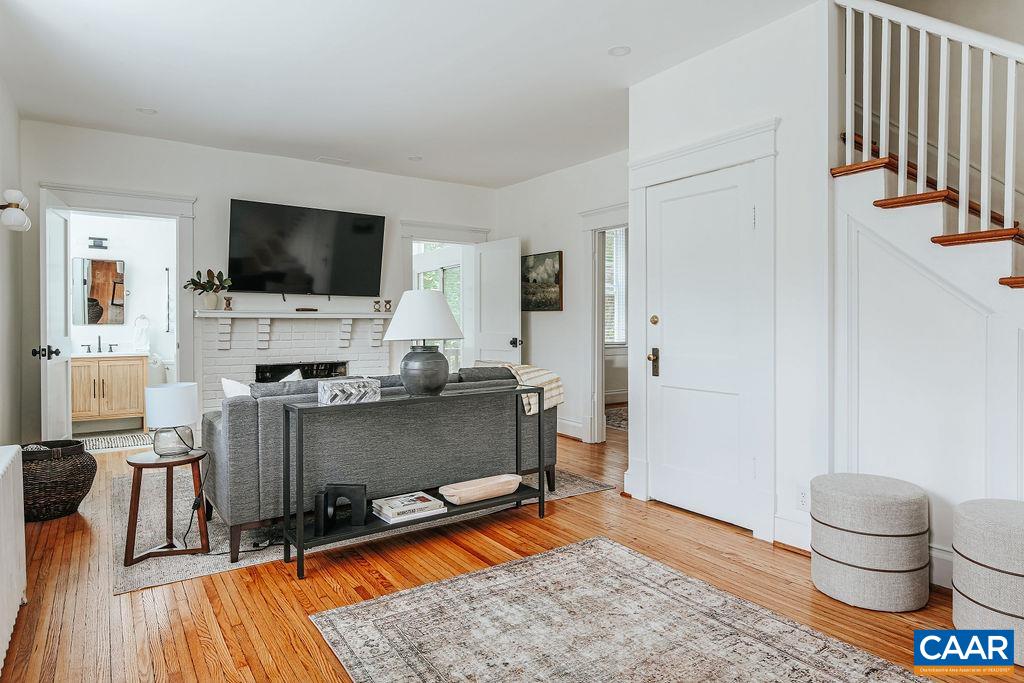 Idyllic cottage, comprehensively renovated, on University Of Virginia's doorstep. Tucked away down a quiet street yet a 5 min walk to Grounds. The main floor features a spacious foyer, inviting living room with a wood-burning fireplace, dedicated dining area, updated kitchen, full bathroom, and convenient laundry room. Heading upstairs you'll find three bedrooms, one of which features a built-in office nook, and a full bathroom. 1935 charm with original hardwood floors, handcrafted wood front door, classic hardware and trim throughout. Thoughtfully designed and decorated by local interior designer to have timeless appeal. Large lot with ample off street parking. R-B Zoning allows for more density. Currently rented through May 2026. A great investment property, weekend home, or full time residence for those wanting to be a stone's throw from everything UVA. Shown by appointment only.