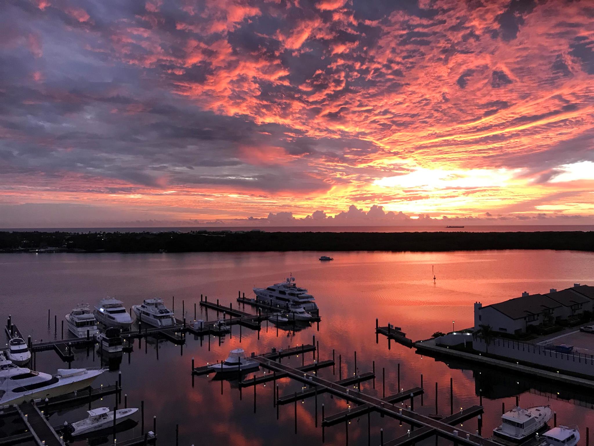 Move right in everything has been done for you! This beautifully renovated 2-bedroom, 2-bathroom luxury condominium on the 12th floor offers an elevated coastal lifestyle with wrap-around deck & breathtaking views from every room, overlooking the Intracoastal Waterway, Singer Island, and the Atlantic Ocean. Enjoy both spectacular sunrises and sunsets.  The condo features new hurricane-impact, floor-to-ceiling windows and sliding glass doors, bringing in abundant natural light and showcasing the incredible views. Completely renovated with high-end finishes, porcelain wood-look plank tile flooring, LED high-hat lighting, new doors throughout, freshly painted. New waterproof decking 2025. Both bathrooms have been remodeled with quartz countertops and nickel cabinet hardware. The primary bathroom includes an oversized shower with porcelain Calcutta large-format wall tile, a dual vanity with generous storage, and a linen closet with built-in shelving. The large primary suite also features a huge walk-in closet with custom shelving and organizers, plus a spacious dressing area with a large mirror.

The stunning kitchen offers granite countertops, a stylish backsplash, reeded glass upper cabinets, and under-cabinet lighting. High-end JennAir and Bosch kitchen appliances. The former passthrough wall was removed to create an open layout that maximizes the expansive views. The dry bar has excellent cabinet storage and matching nickel hardware.

Additional interior features include ceiling fans in the living room and primary bedroom, decorator crown molding and baseboards, and a spacious laundry room with cabinetry, a quartz folding shelf, and newer Whirlpool full-size washer and dryer. There is also a coat closet in the foyer and a storage closet located just outside the unit. Mechanical updates include a new AC (2022), new hot water heater (2024), an upgraded electrical panel, new lighting with dimmers, and all new California-style closets and cabinetry throughout. Enjoy the views from the expansive wrap-around balcony, and appreciate the newer window treatments already in place.  New waterproof decking 2025.

Community amenities include a 24-hour manned gatehouse, pool, hot tub, summer BBQ area, multiple lounge areas, and community room with kitchen perfect for entertaining. Residents also enjoy a 2-mile waterfront walking path around the complex and the adjacent, independently operated Safe Harbor Marina with dock rentals, fuel services, and direct ocean access. All-ages building. Small pet allowed.