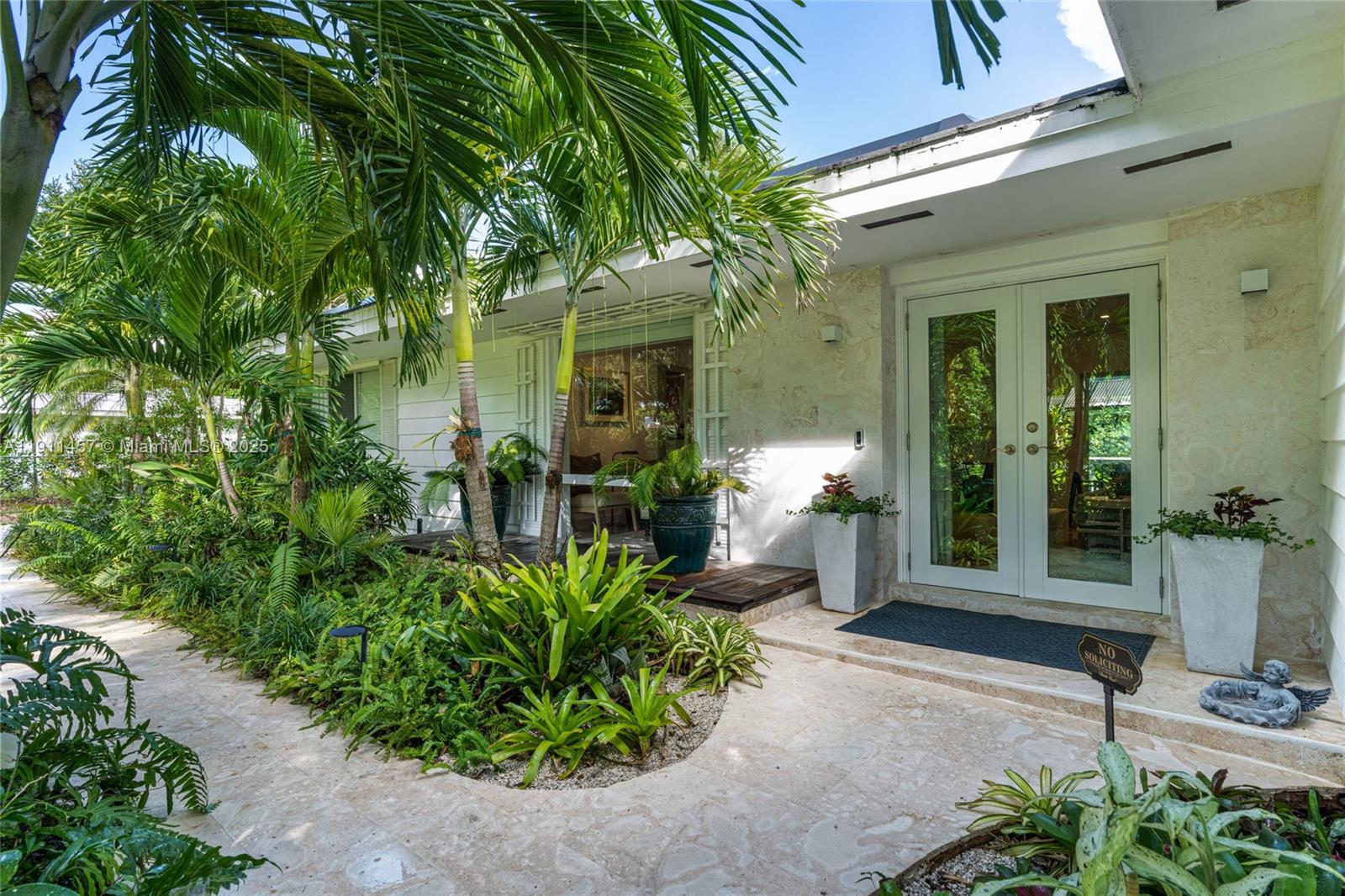 Impeccably updated and thoughtfully designed one-story 3-bedroom, 2-bath residence in a wonderful neighborhood. Upgrades include a Tesla solar panel system with backup batteries, solar water heater, new AC, and fully renovated bathrooms. Refined marble and wood floors flow throughout, complementing the high-end eat-in kitchen with custom cabinetry and a wall-to-wall storage unit. Step into a resort-style backyard—an exquisite screened-in pool oasis with jacuzzi, oversized covered terrace, and lush tropical landscaping, perfect for both relaxing and entertaining. Additional features include a impact doors and windows, newer roof, paver driveway, dual storage areas, and a prime location near top-rated private and publics schools and the Deering Estate.