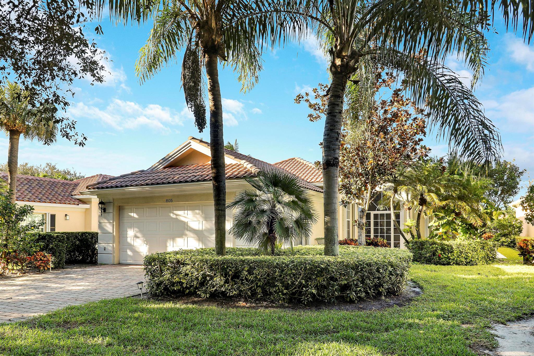 Wake up to sun-kissed water views and the sound of palm trees swaying in The Isles of Palm Beach Gardens. This inviting Oakmont blends warmth and elegance with high ceilings, open living spaces, and natural light throughout. The kitchen's crisp white cabinetry and stainless appliances overlook the great room, perfect for gathering with friends. Step outside to your private screened pool and watch the sunset dance across the lake, true Florida living at its finest, just minutes from beaches, golf, and all that PGA Boulevard has to offer.