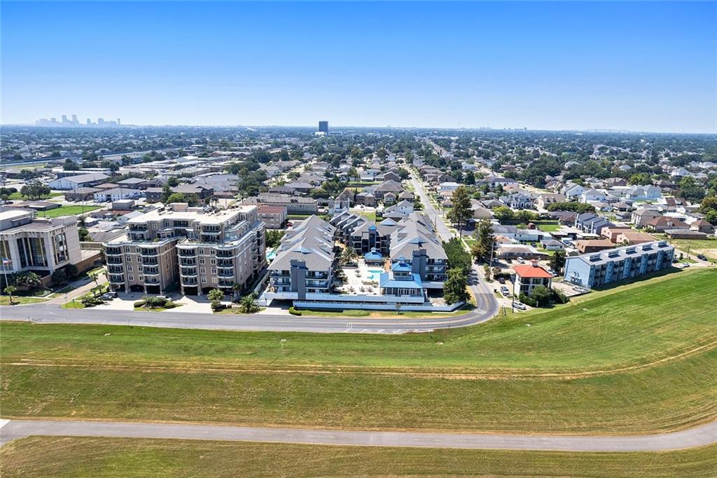Welcome to this absolutely stunning 2-bedroom, 2-bathroom condo in the heart of Bucktown! Brimming with character and natural light, this beautifully maintained home features soaring ceilings, an open-concept layout, and an updated kitchen complete with granite countertops, painted cabinetry, and stainless steel appliances.

Step through the large sliding glass doors to your private balcony and enjoy serene views of Lake Pontchartrain and the levee — the perfect spot to relax or entertain. The spacious downstairs primary suite offers abundant light, a generous walk-in closet, and a tastefully updated bathroom with a large walk-in shower. Upstairs, the loft-style second bedroom provides plenty of space, a full bathroom, and a dedicated closet — ideal for guests, an office, or a creative retreat.

Additional highlights include in-unit laundry, a reserved covered parking space, and a private storage unit. The community has recently been enhanced with a beautifully renovated outdoor area featuring a sparkling new pool, cabana, and lush landscaping. Gated access throughout the property provides added peace of mind, and the condo association is well-managed and financially sound.

All appliances are included, and the condo can be sold partially or fully furnished for added convenience. Located just blocks from Bucktown’s best restaurants, shops, and the waterfront, this is truly a wonderful place to call home.

Please note: while there is elevator access from the parking lot to the second floor, entry to the unit requires a short flight of stairs.

Don’t miss your opportunity to own this beautiful Bucktown gem