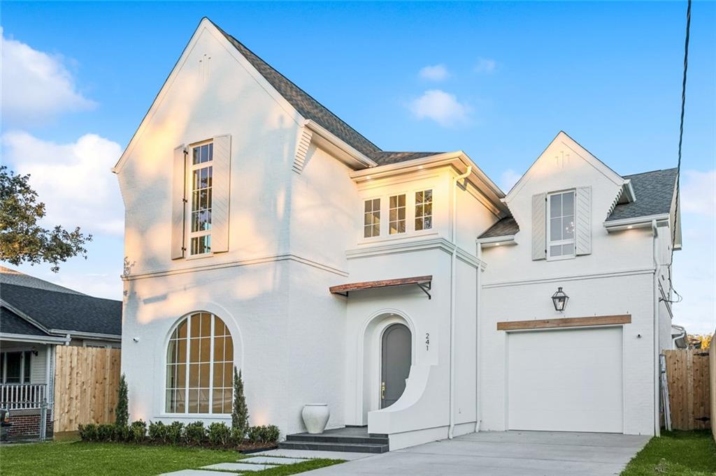 Experience luxury living in this breathtaking brand-new construction located in one of Old Metairie’s most coveted pockets. Situated on an exceptionally deep 50’ x 150’ lot, this all-brick architectural masterpiece blends timeless design with modern sophistication, complete with custom brickwork and a striking real copper awning over the arched front entry.
Step inside the soaring 22-foot foyer, illuminated by a statement chandelier and framed by elegant arches that guide you through the home’s thoughtfully curated spaces. The first-floor primary suite offers a true retreat with a beautifully designed closet connected directly to a custom laundry room. The spa-inspired primary bath features his and hers vanities with toe-kick lighting, a sculptural fluted soaking tub, and a glass-enclosed shower with an illuminated niche.
The open-concept living and kitchen area is designed for effortless entertaining. The chef’s kitchen showcases custom cabinetry, a refined blend of white oak and classic white, surrounding a premium 48” Thermador range, matching Thermador refrigerator and freezer, a handcrafted rounded hood, and a pot filler. Tucked behind the main kitchen, the scullery kitchen adds another full sink, dishwasher, extensive storage, and abundant prep space. A walk-in pantry and dedicated private home office add everyday convenience.
Host unforgettable gatherings in the stunning dining room, highlighted by a custom wood ceiling, designer chandelier, and large windows overlooking the expansive backyard. A beautifully crafted half bath with a custom white oak reeded vanity and designer picture lighting elevates the first-floor aesthetic even further.
Functionality meets luxury with a generously sized one-car garage featuring custom storage shelving that leads directly into the mudroom ideal everyday drop zone. The home also includes built-in surround sound and a security camera system for comfort and peace of mind. Outdoor living becomes an extension of the home with a spacious rear porch boasting real stone pavers, a full outdoor kitchen, and a retractable screen system for year-round enjoyment. An exterior half bath, perfect for future pool plan, adds unmatched practicality for this oversized yard. Upstairs, a bright loft, second laundry room, and two additional bathrooms support well-appointed bedrooms, providing flexibility for family, guests, or multigenerational living. From its premium finishes to its rare lot depth and sophisticated layout, this Old Metairie residence offers the perfect balance of luxury, comfort, and architectural excellence, all in one of the area’s most desirable locations.