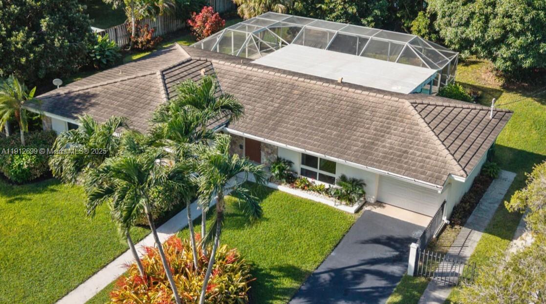 Discover serenity in this Palmetto Bay pool home, where tropical living meets everyday comfort. This 3-bed, 2-bath CBS home offers open, easy flow from indoors to an immense screened patio and sparkling tiled pool. The primary suite, with walk-in closet, feels private and peaceful, while impact windows and doors add quiet confidence and energy efficiency. Cabana Bath & outdoor shower add to pool fun. The lush backyard features fruit trees and plenty of room for outdoor enjoyment.  For your vehicles there’s a one-car garage plus driveway and additional gated parking. Renowned Coral Reef Park is just minutes away, where you can enjoy a host of activities.  This desirably located home on a large 1/3 Acre lot delivers style, function, and serenity and is ready to become your own private oasis.