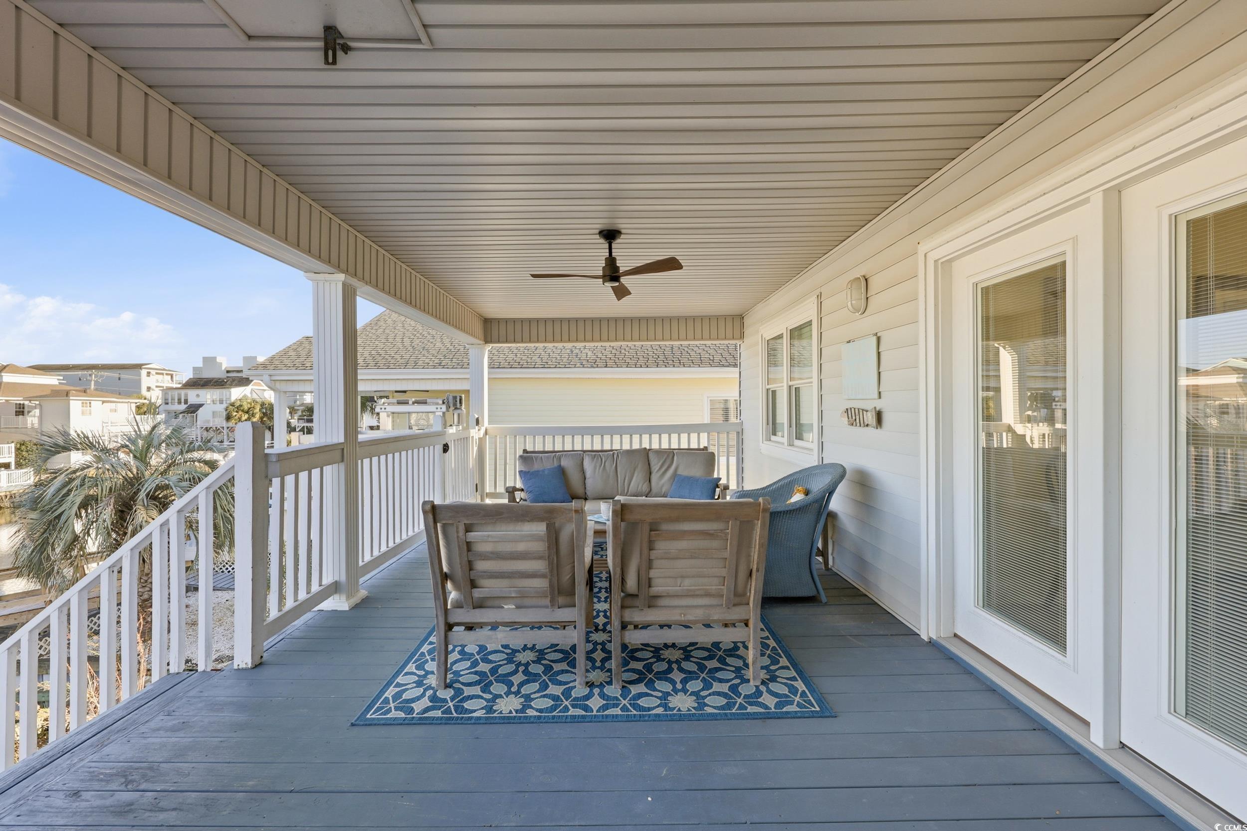 Wooden terrace featuring an outdoor living space and a ceiling fan