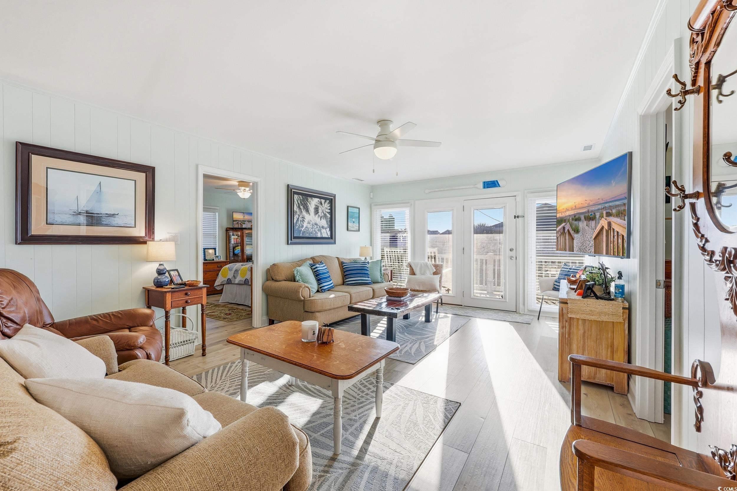 Living area featuring wood finished floors and ceiling fan